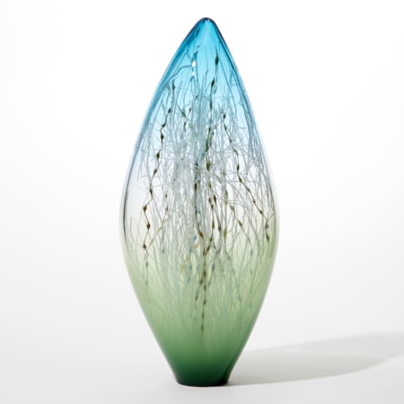 tall slender ovoid glass sculpture with pointed transparent aquamarine top clear middle fading to opaque forest green base with the inside filled with a myriad of fine straight and undulating canes in ochre blue teal and brown