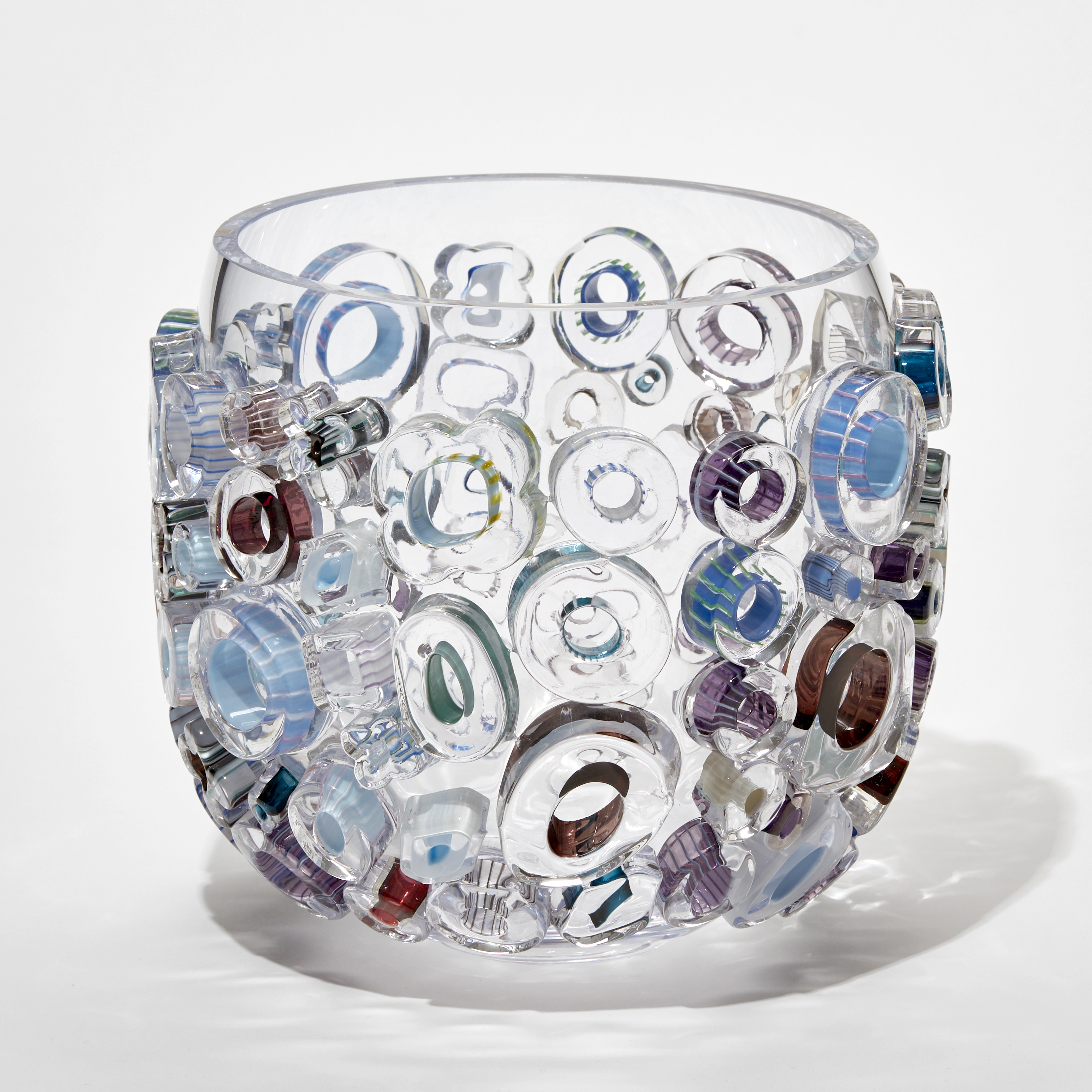 clear glass sculpted vessel with external circular glass adornments