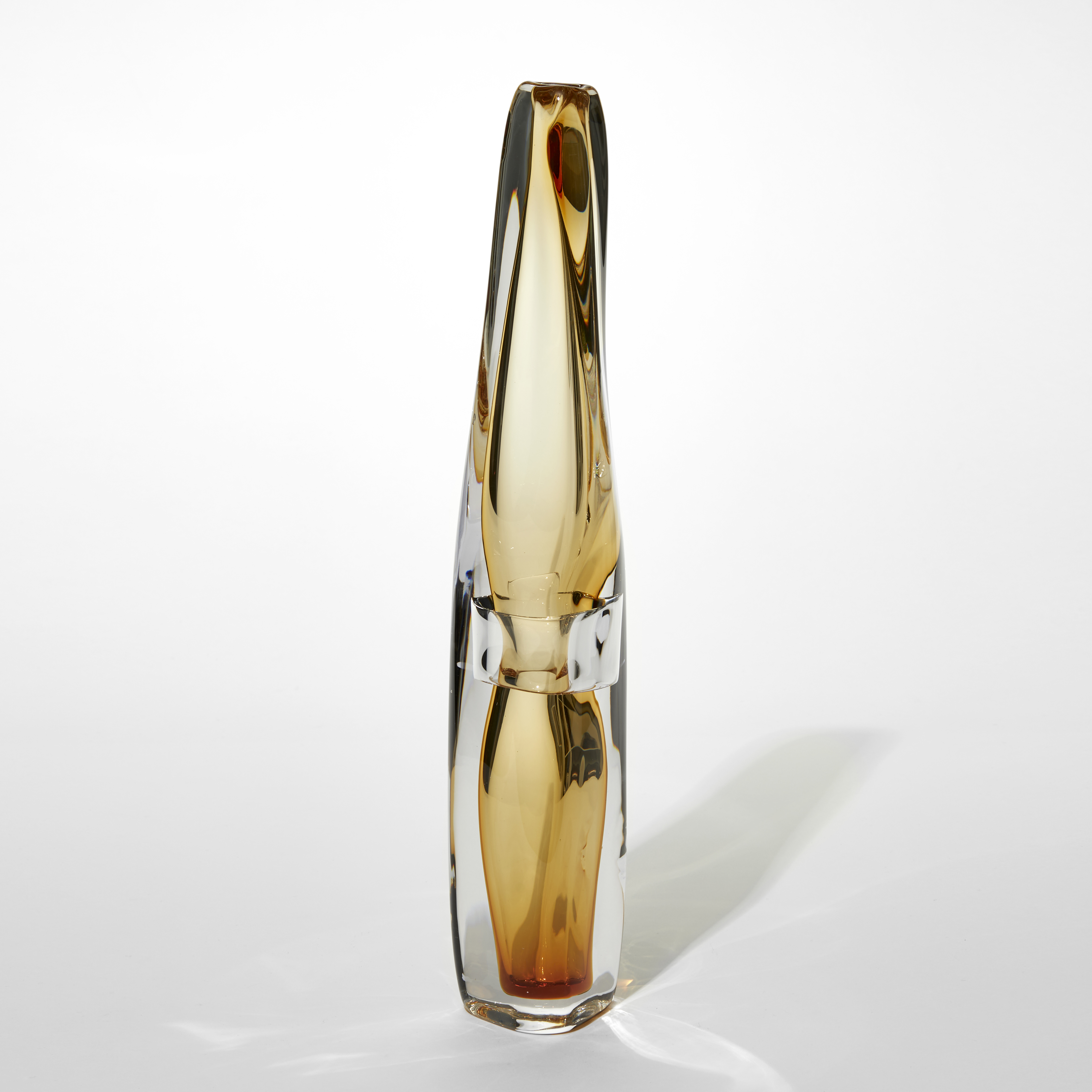 transparent tall organic soft vase with clear outer layer and soft amber inner layer with pinched in waist via a clear band hand made from glass