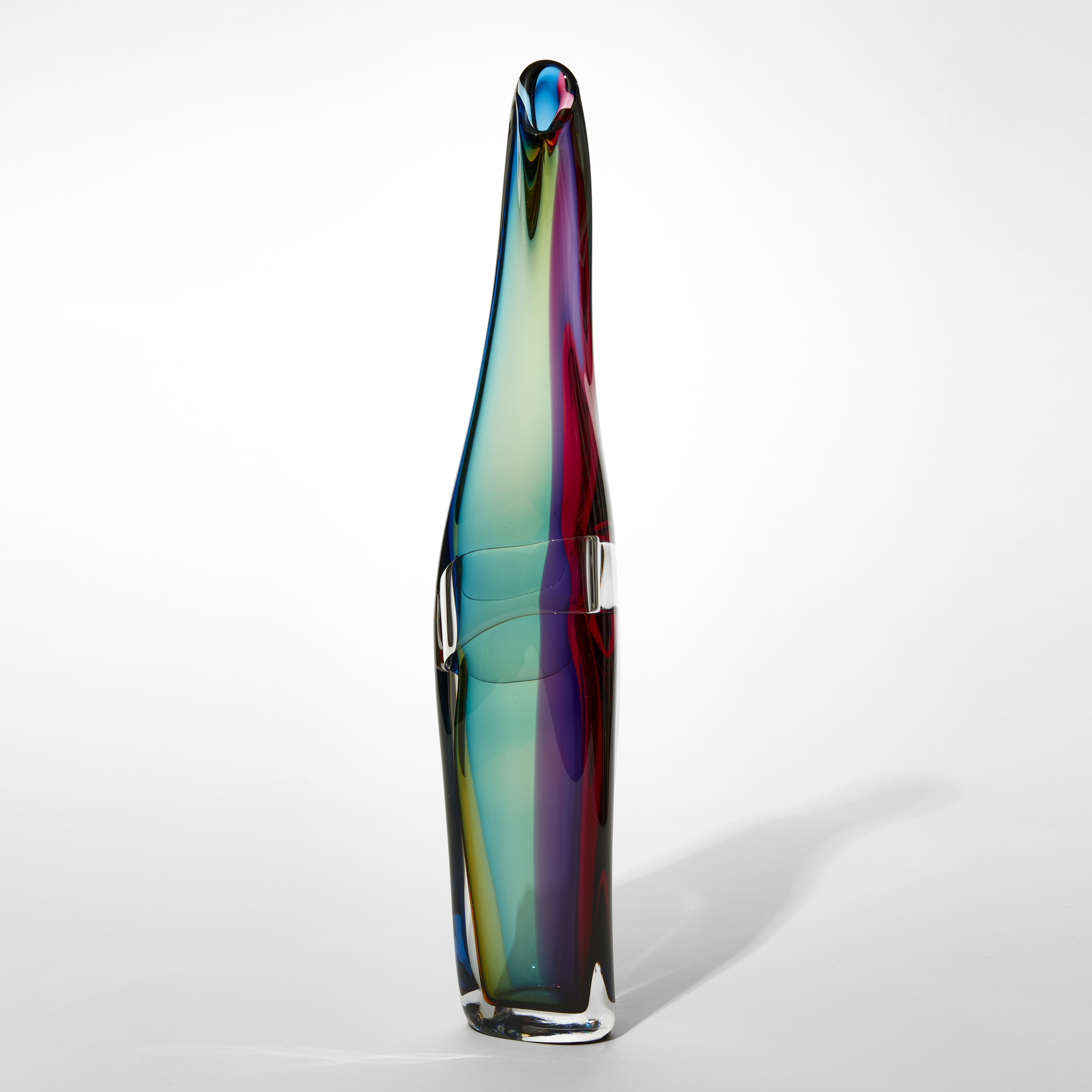 twisting standing vase with fluid lines and merging bands of transparent colour in sea green gold purple and red hand made from blown glass