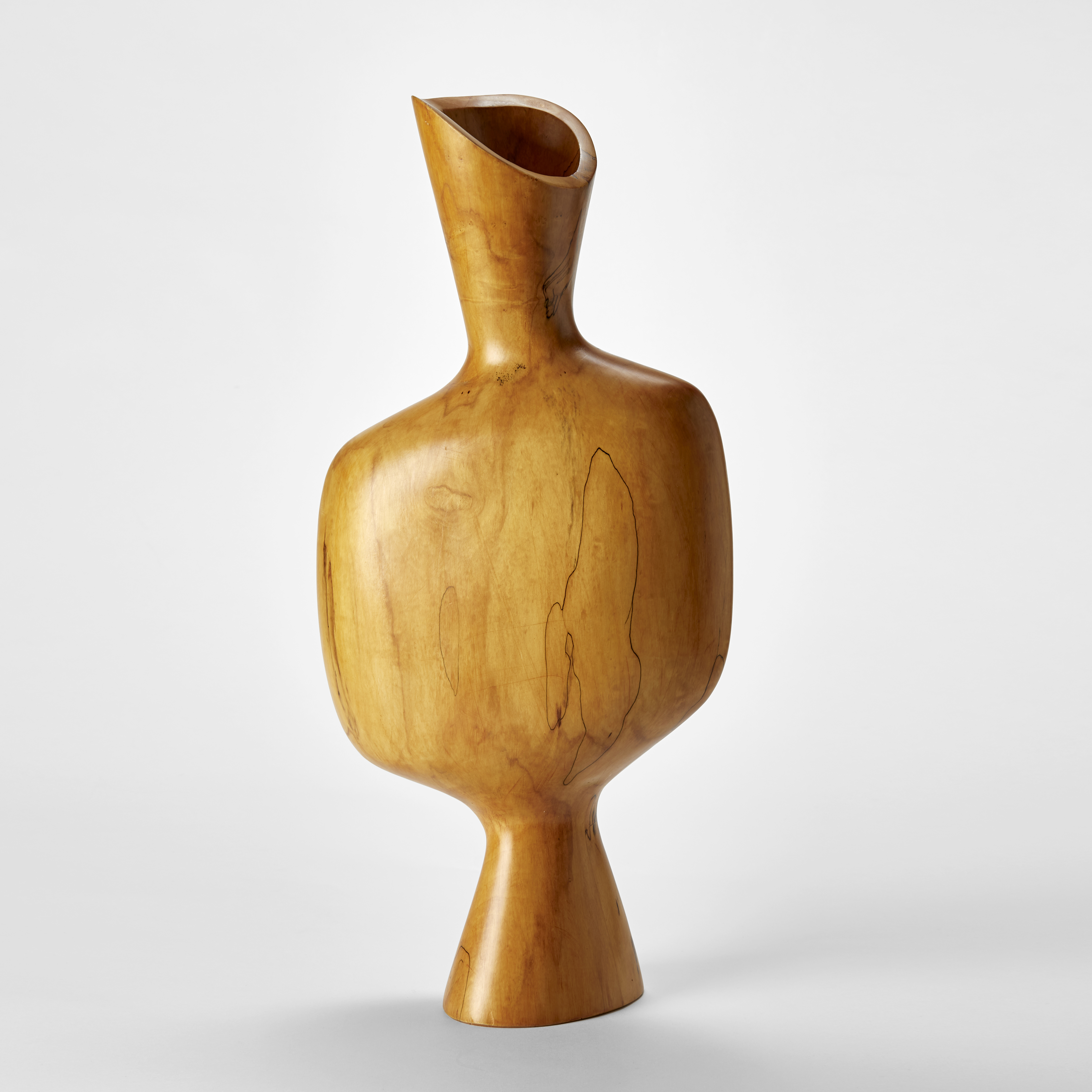 standing light honey coloured wooden sculpture with narrow cone shaped base wider soft squared middle and long narrow flaring opening