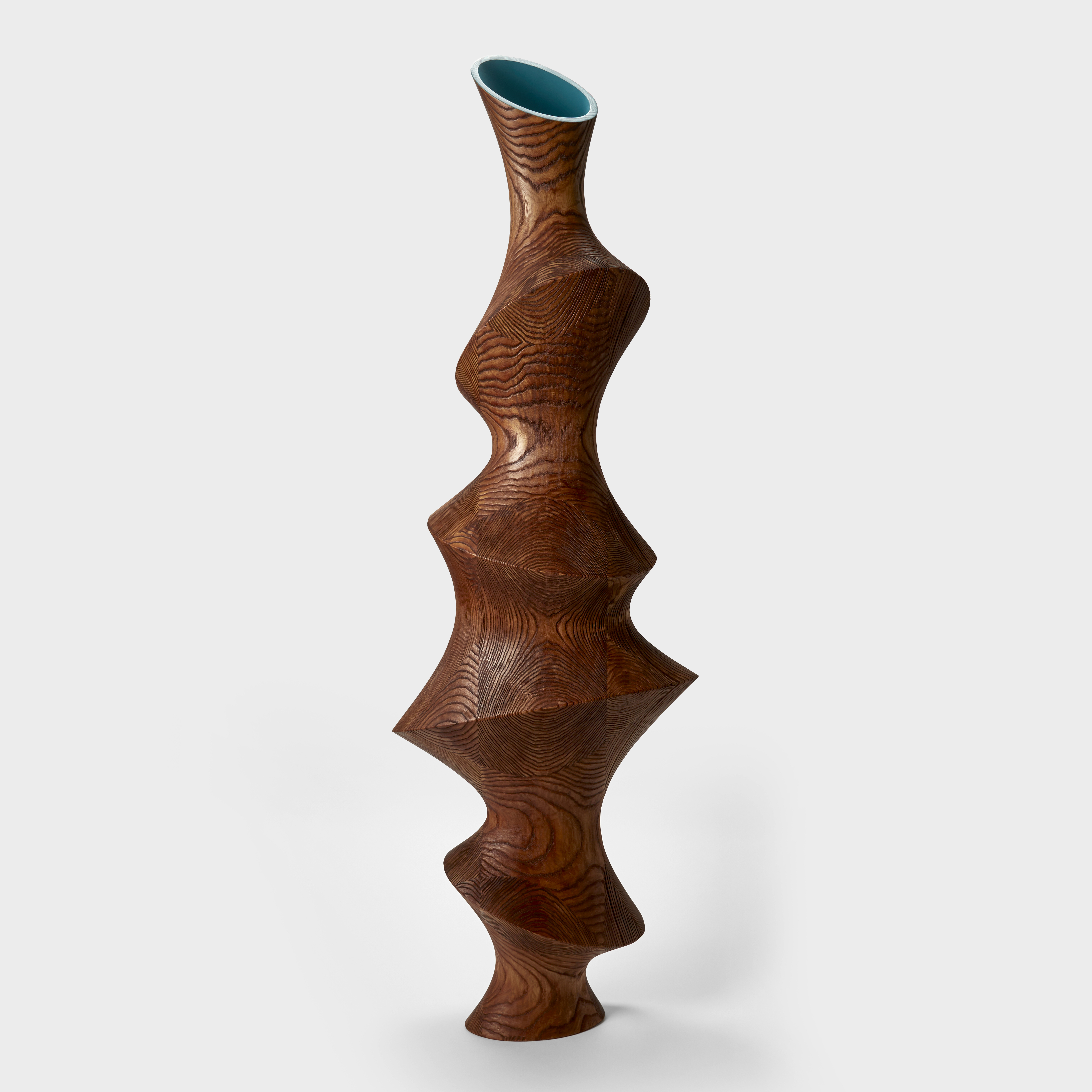 tall wooden form with undulating looping circular sides creating repeating differing sized waisted sections with incised surface with the appearance of oversized fingerprints and top opening in bright turquoise