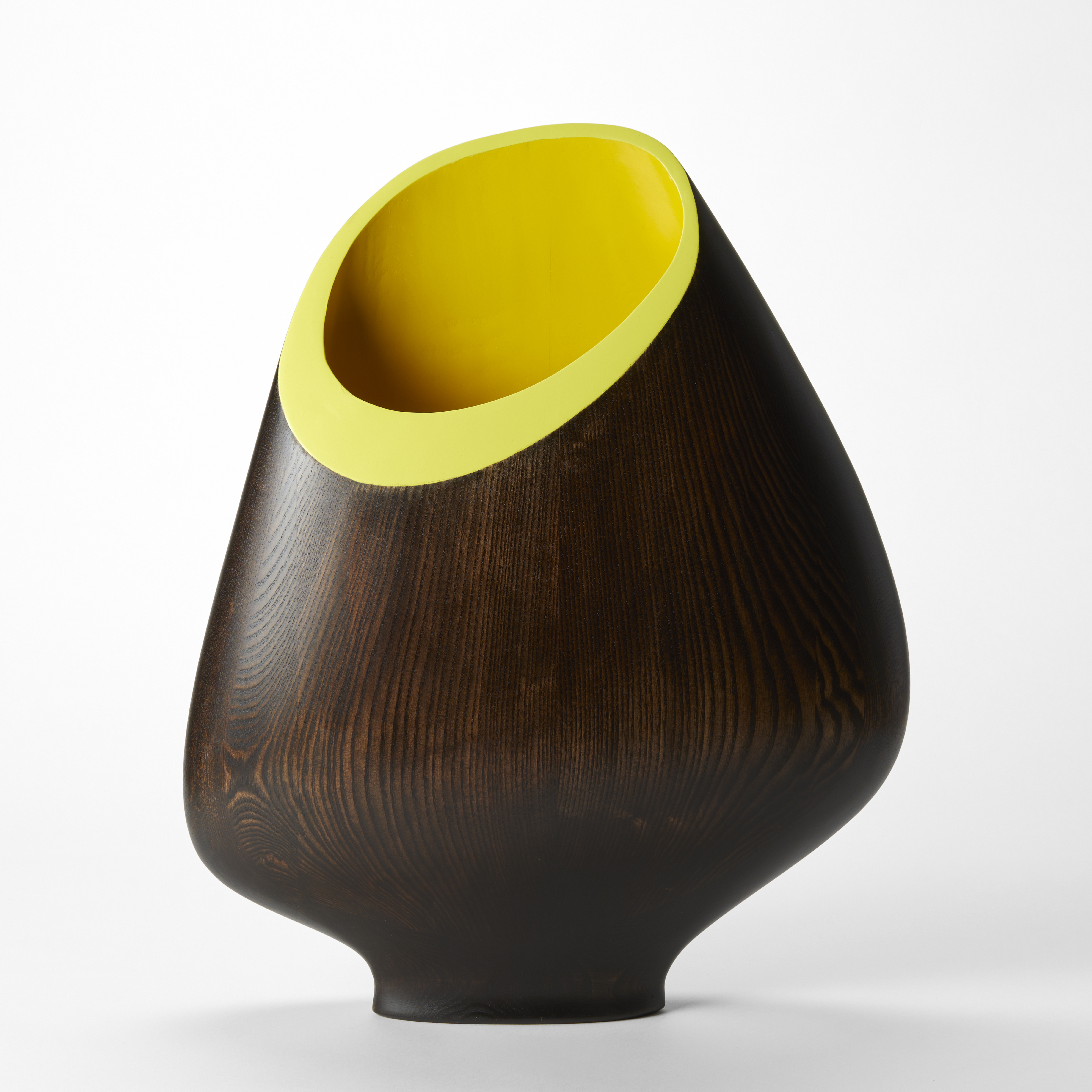 wide open mouthed flattish vessel with tapered elegant foot sweeping and rounded sides hand made from dark ash wood with distinct grain and angled large round opening in bright yellow with flat rim