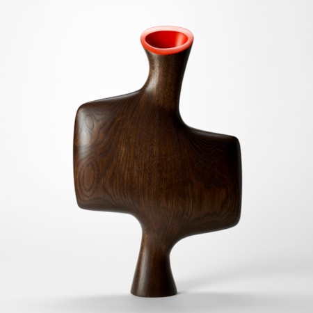 abstract standing sculptural vessel hand made from oak with asymmetric form  in the shape of a bisected offset square with flat front and back a tapered foot and top angled opening in bright red