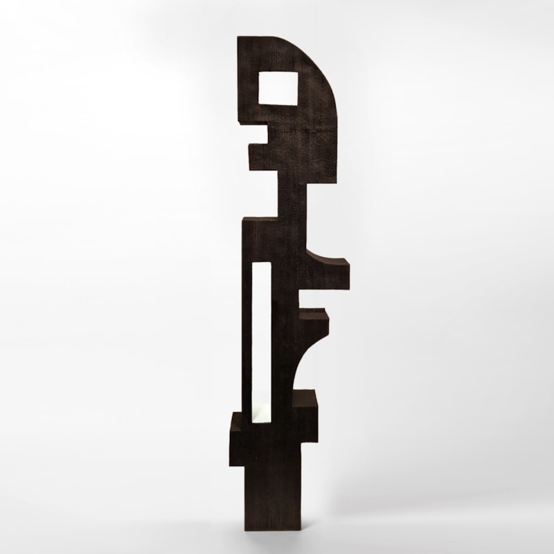 tall black standing abstract masai inspired sculptural figure made from sapele wood with a rectangular window opening lined in white