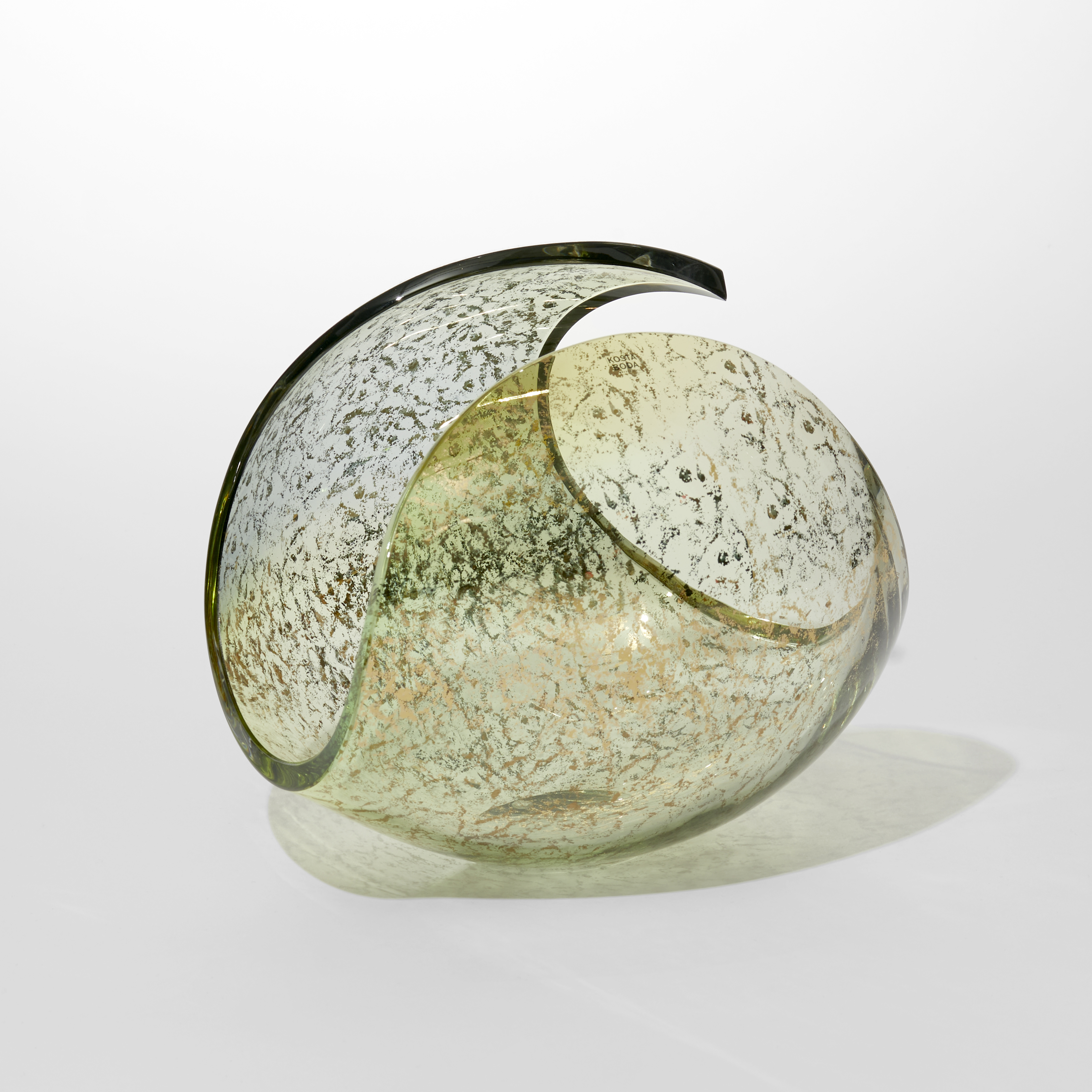 transparent lime green ovoid with cut away section leaving a traversing looping rim hand blown from glass with an exterior gold pattern sponged onto the surface