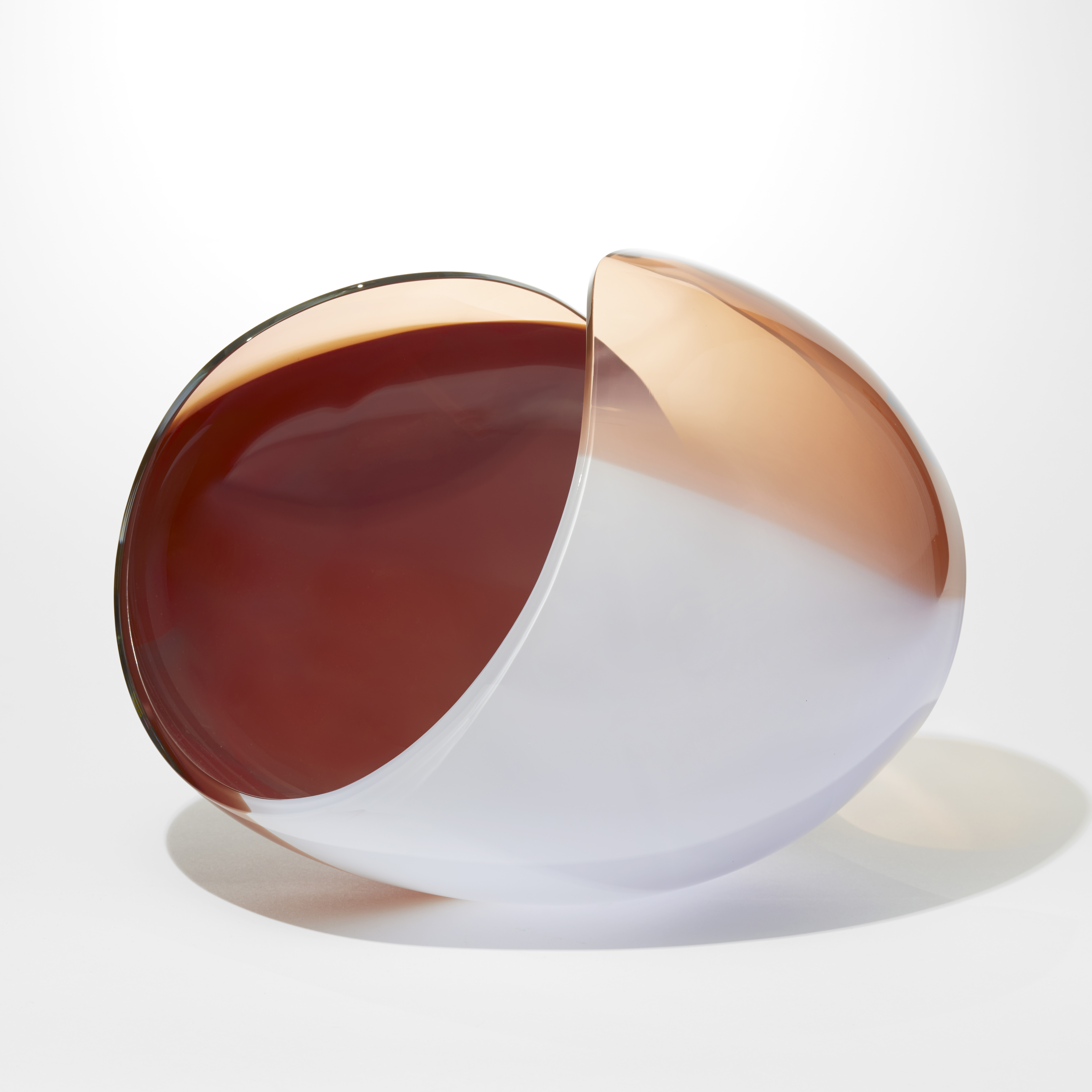 ovoid with cut away elliptical area leaving a figure of eight looping rim hand blown from opaque soft grey peach and ox blood red glass