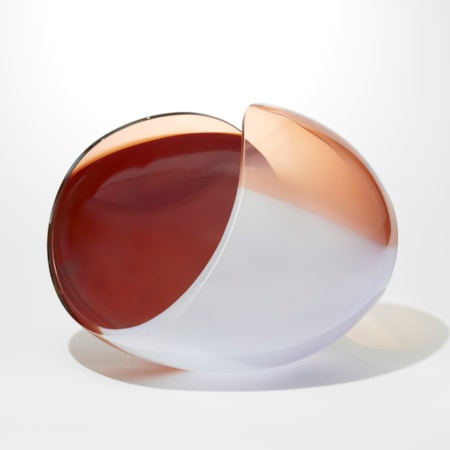 ovoid with cut away elliptical area leaving a figure of eight looping rim hand blown from opaque soft grey peach and ox blood red glass