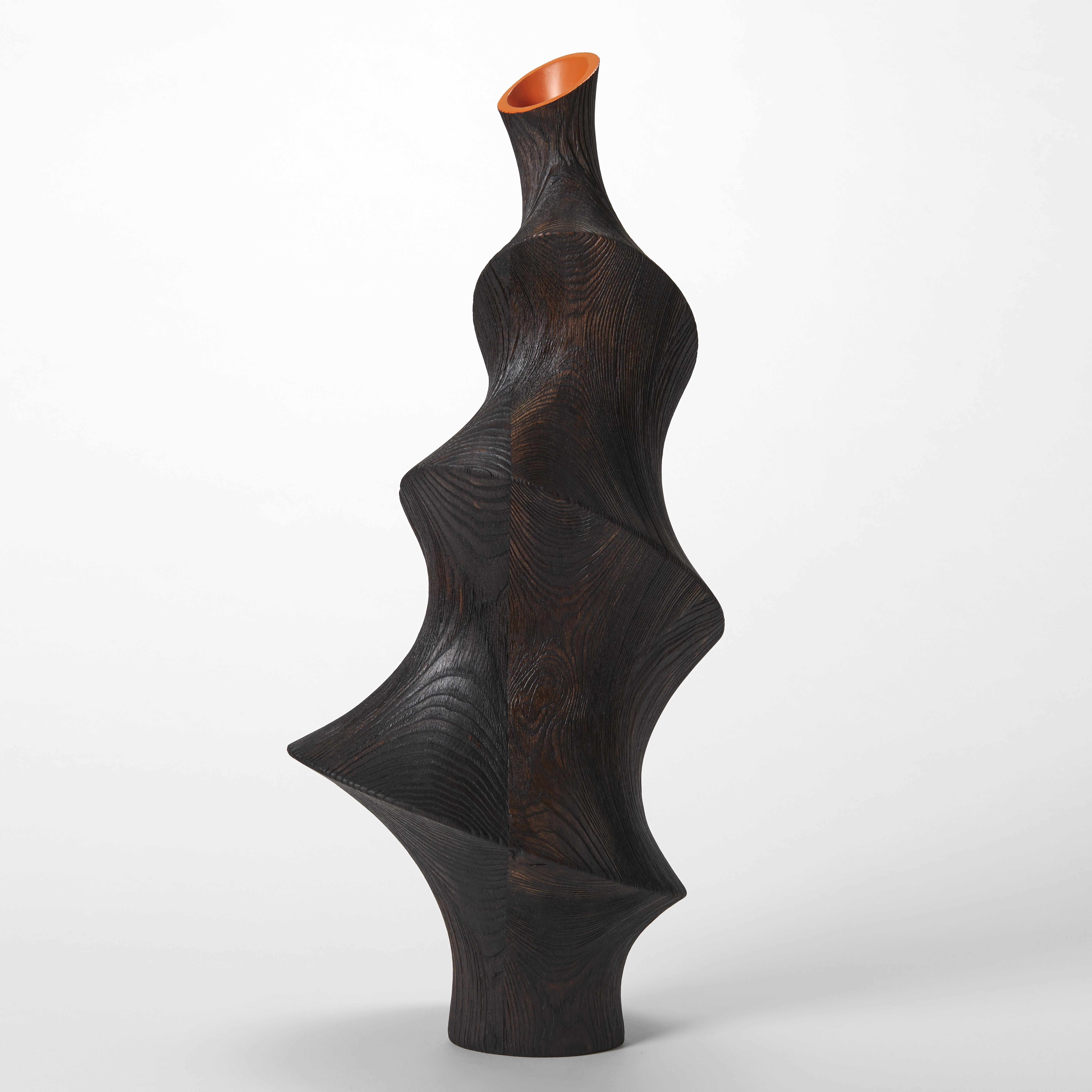 tall undulating black ridged surface form with decreasing width and top final small angled opening with bright orange interior hand made from ash