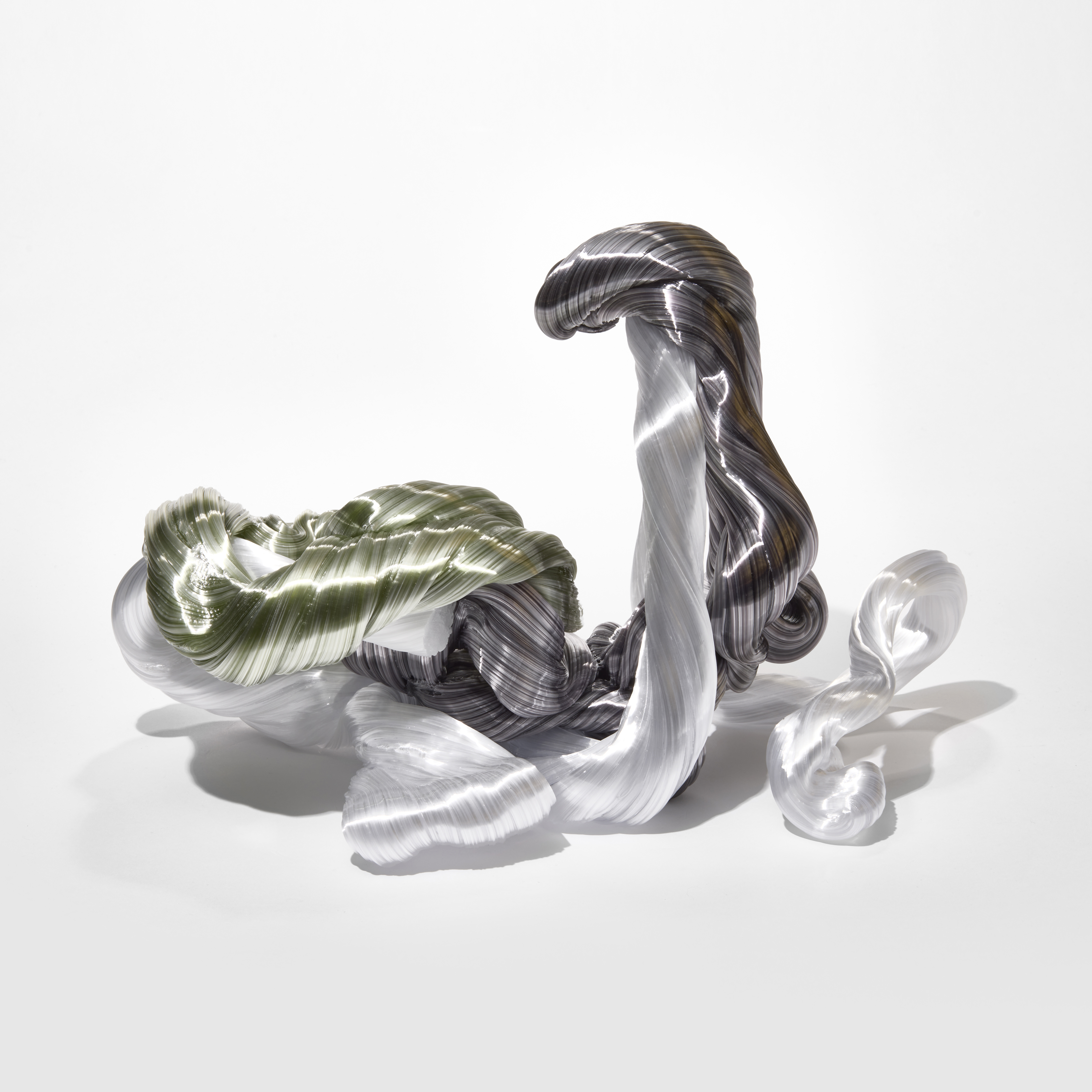 writhing looping mass of opaque glistening twisted ropes in grey white and soft olive green hand made from sculptured glass