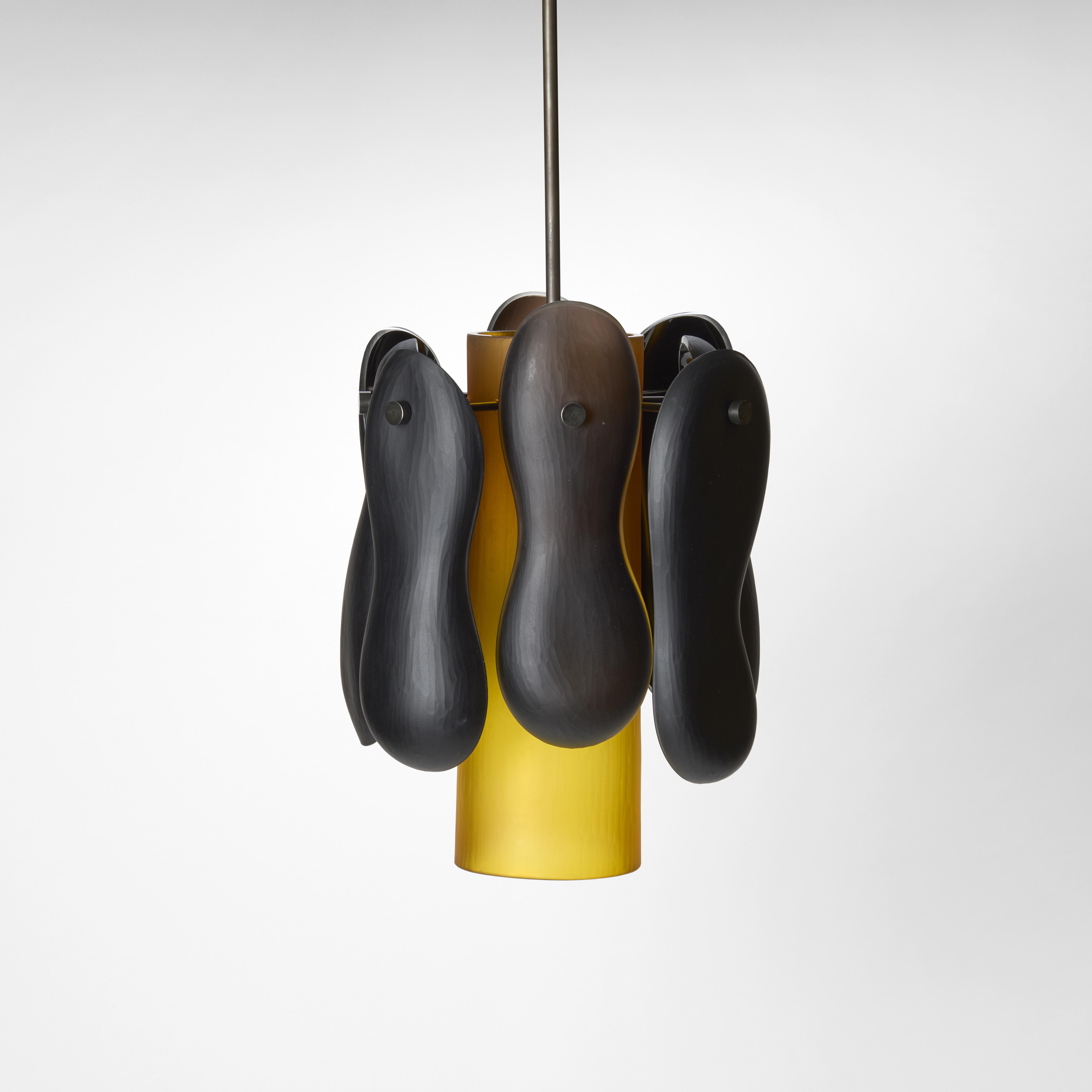 soft opaque pendant light with central column in amber gold surrounded by eight bean figure of eight shapes in black and brown handing from the top hand made from blown and cut glass