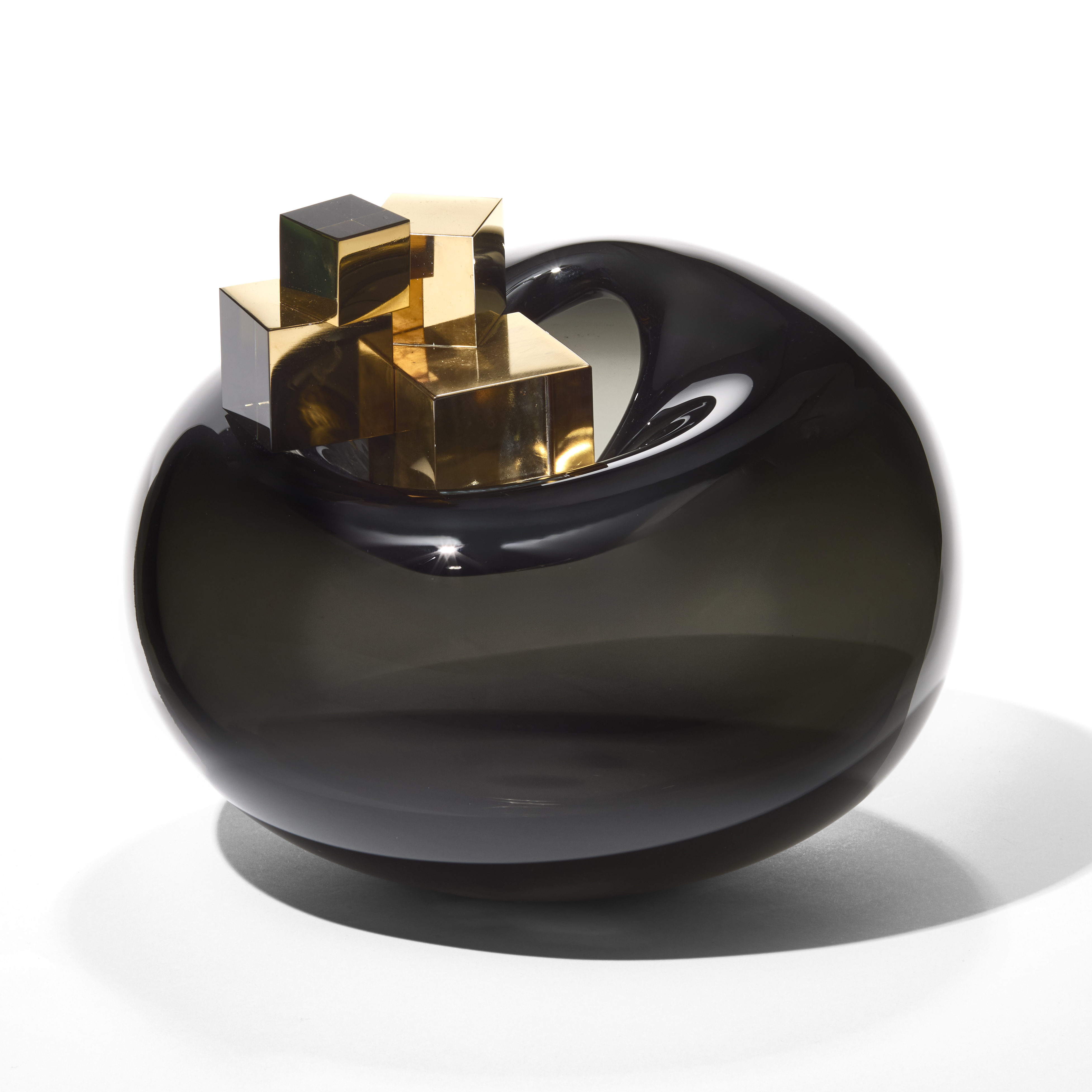 large round squat dark grey glossy transparent bubble with three large gold cubes balanced on the top hand blown from glass with gold lustre