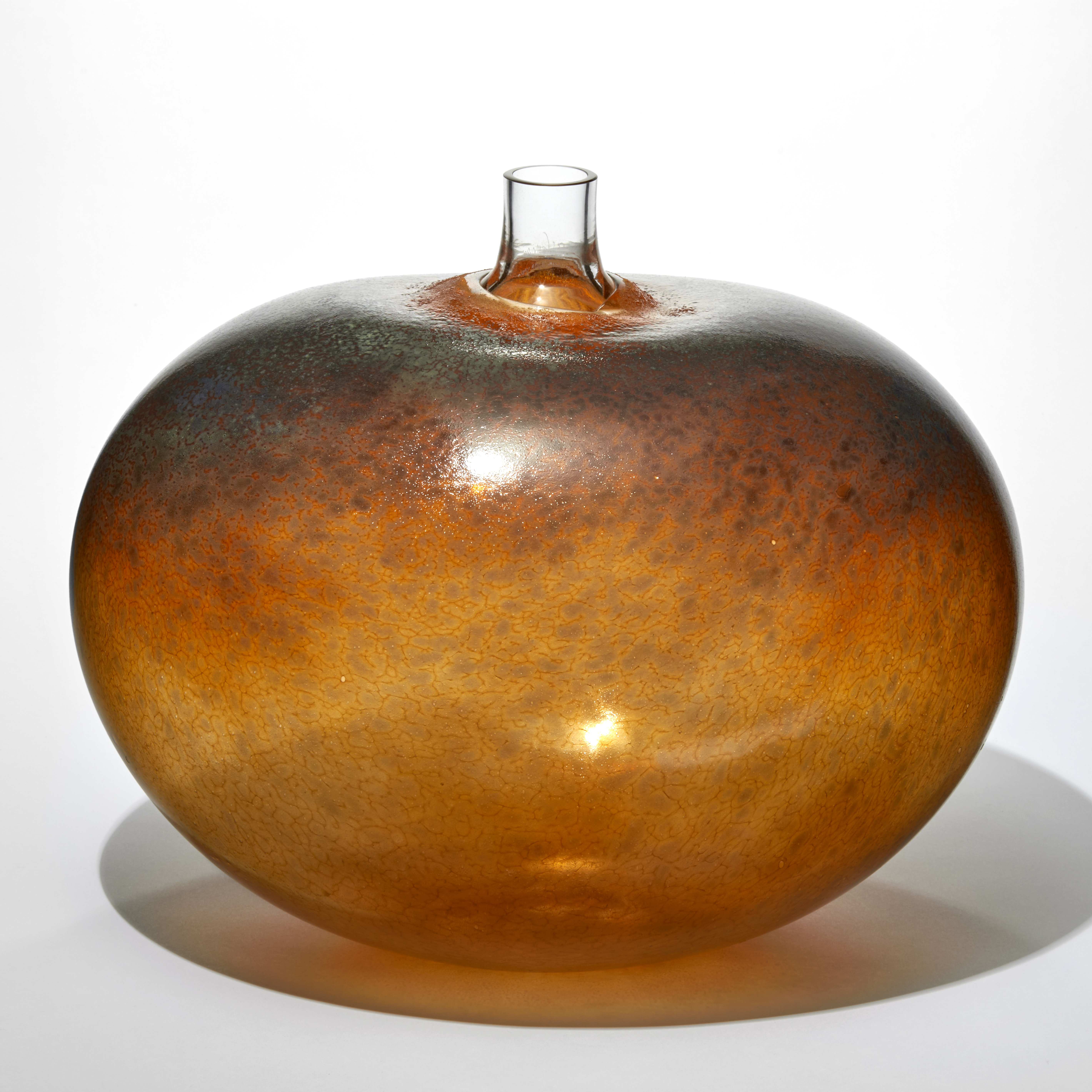 fat round bean shaped transparent amber rust and dark brown vessel with a mottled surface pattern and short clear tubular stork thrusting from the top