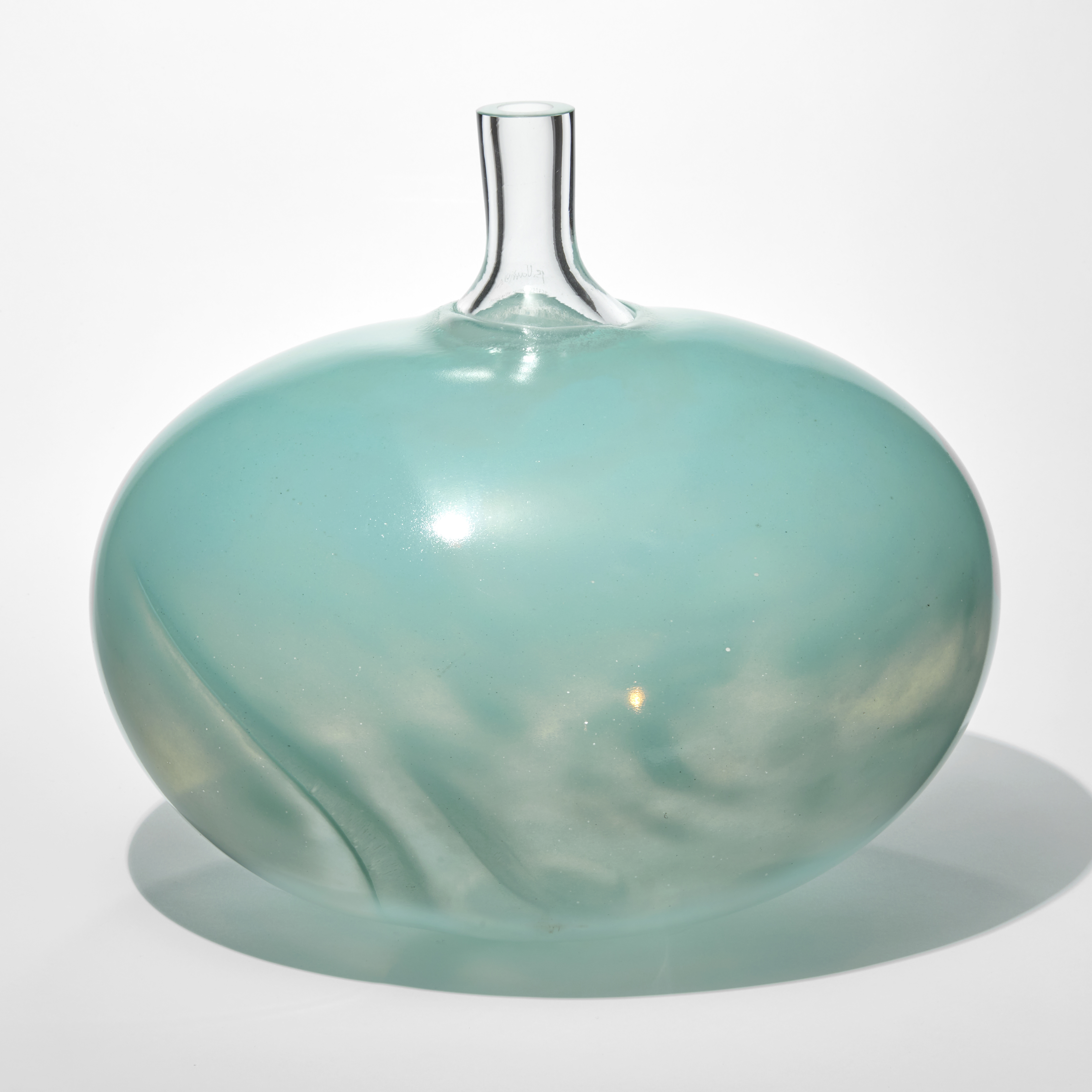 rounded bean shaped vessel with a swirling transparent and opaque aquamarine lower half with an opaque turquoise top with a tubular clear neck protruding from the top hand made from glass