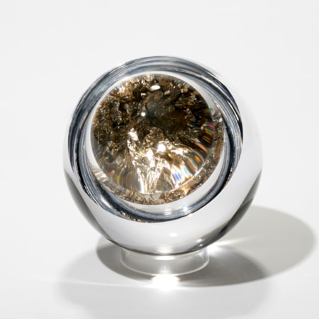 clear round orb with the centre filled with crushed moon gold leaf with a convex lid bonded on trapping the leaf inside acting as a lens and enlarging the contents hand made from blown and cut glass