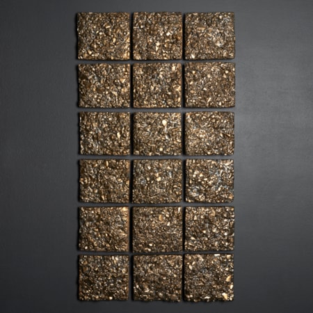 bronze and golden wall mounted installation consisting of 18 squarish rectangular small panels each with a highly textured rock like surface hand made from clay