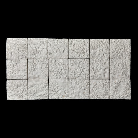 landscape wall installation consisting of 18 white square panels presented very close to give the effect of one large plain with each with a soft lunar surface with sections with repeat ridges and soft protruding rocks hand made from clay