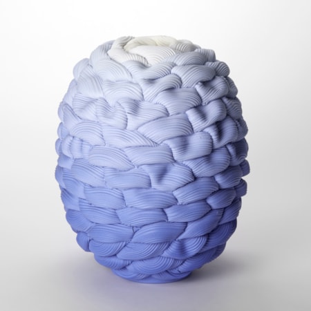 round squat barrel shaped vase with small opening at the top created from stacked interwoven ridged rings fading from dark intense blue at the base through to white at the top hand made and thrown from parian porcelain