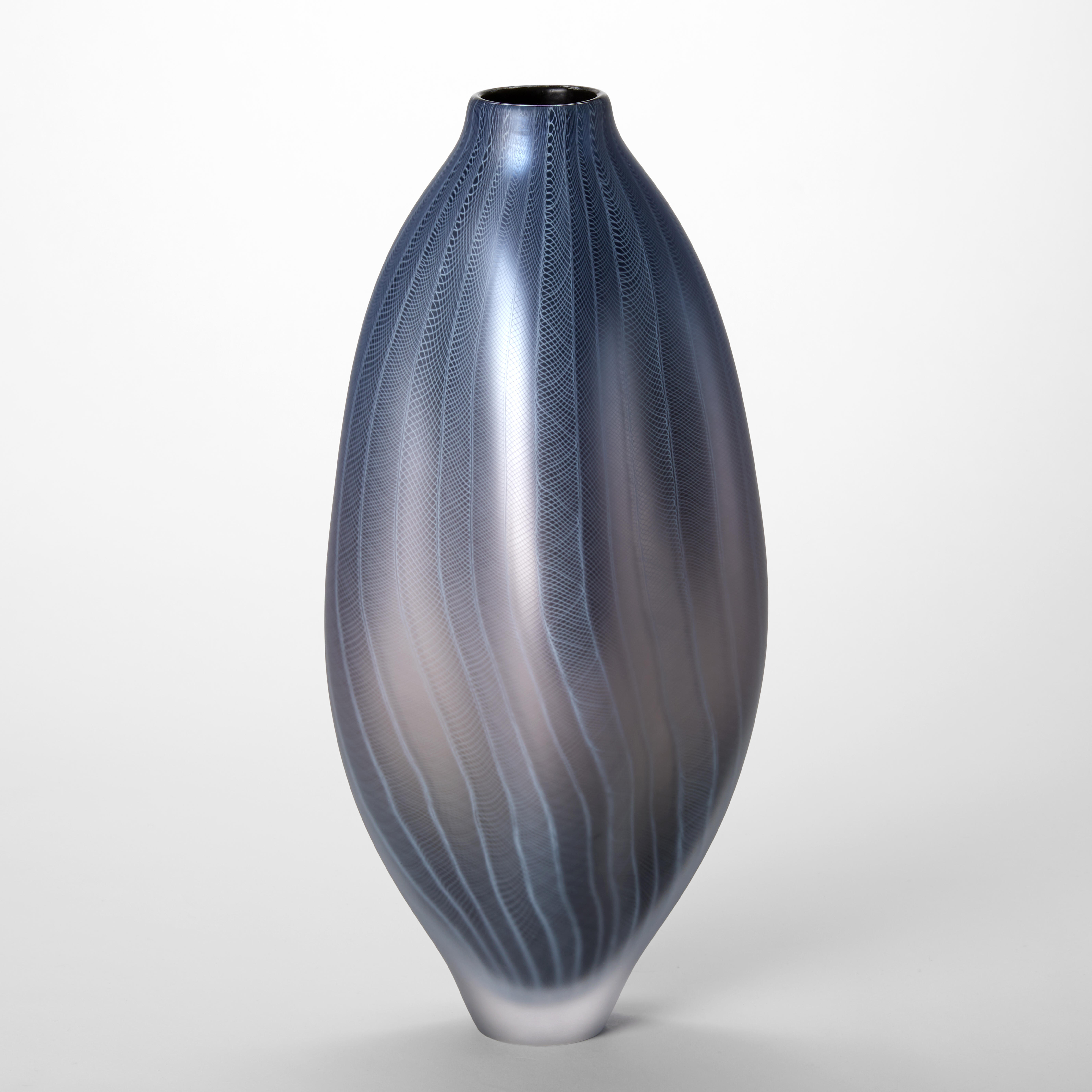 tall rounded undulating vessel with small foot and small top opening in a metallic soft steel blue grey and aubergine with fine laced white lines on the surface hand made from glass