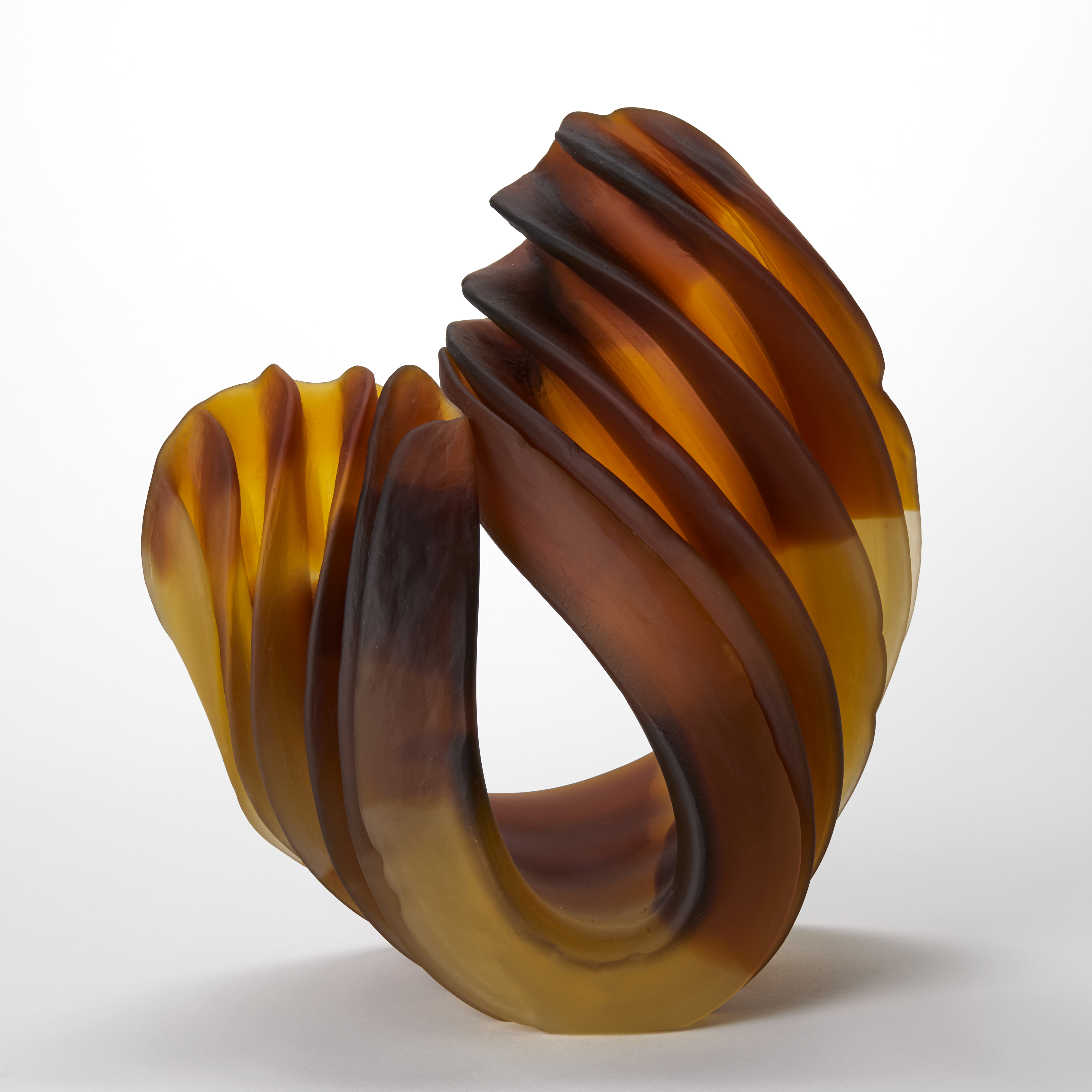 curved ridged opaque form in yellow ochre and amber hand made from cast and bent glass