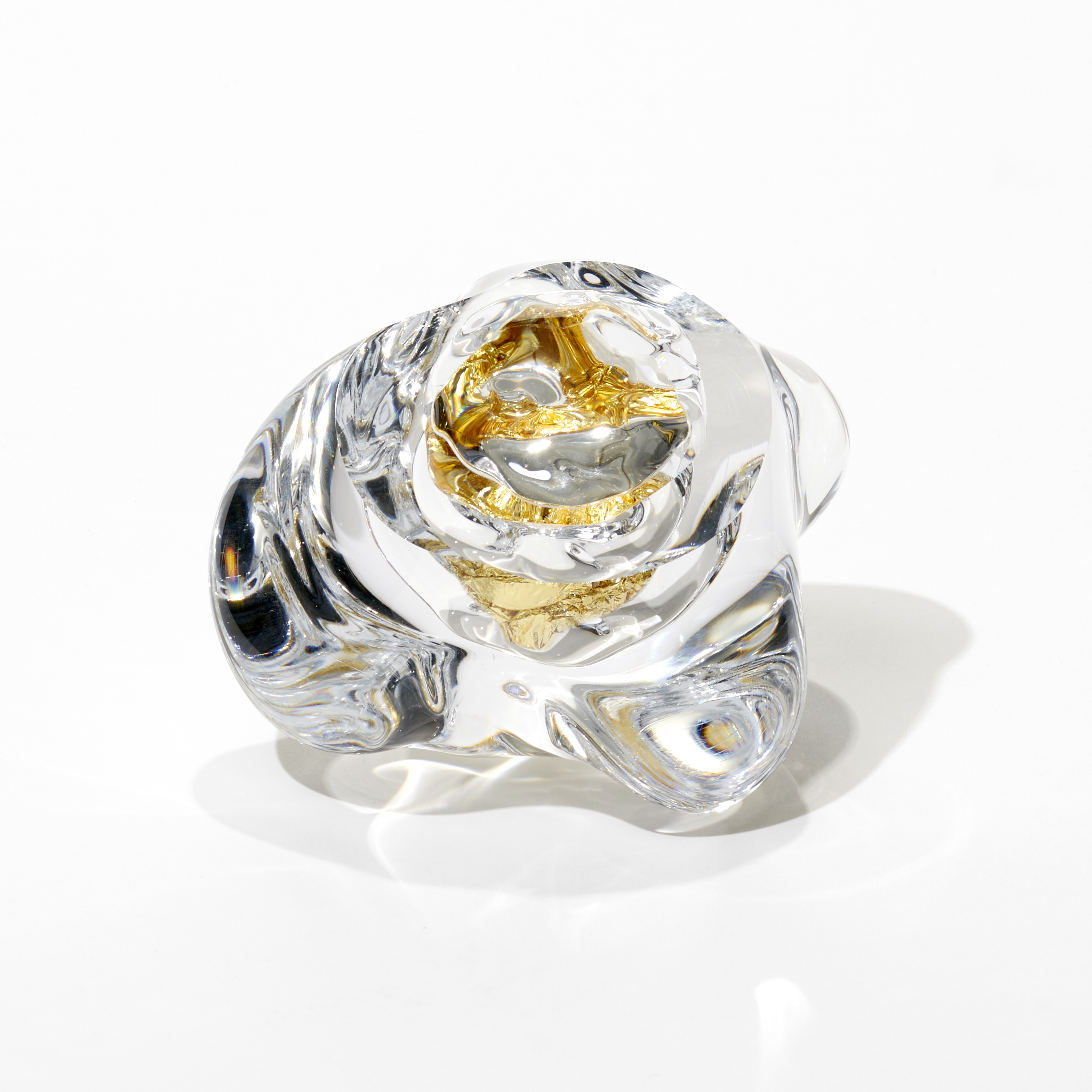 clear amorphous soft ice and rock like sculpture with the centre filled with crushed gold leaf hand blown and cut from glass