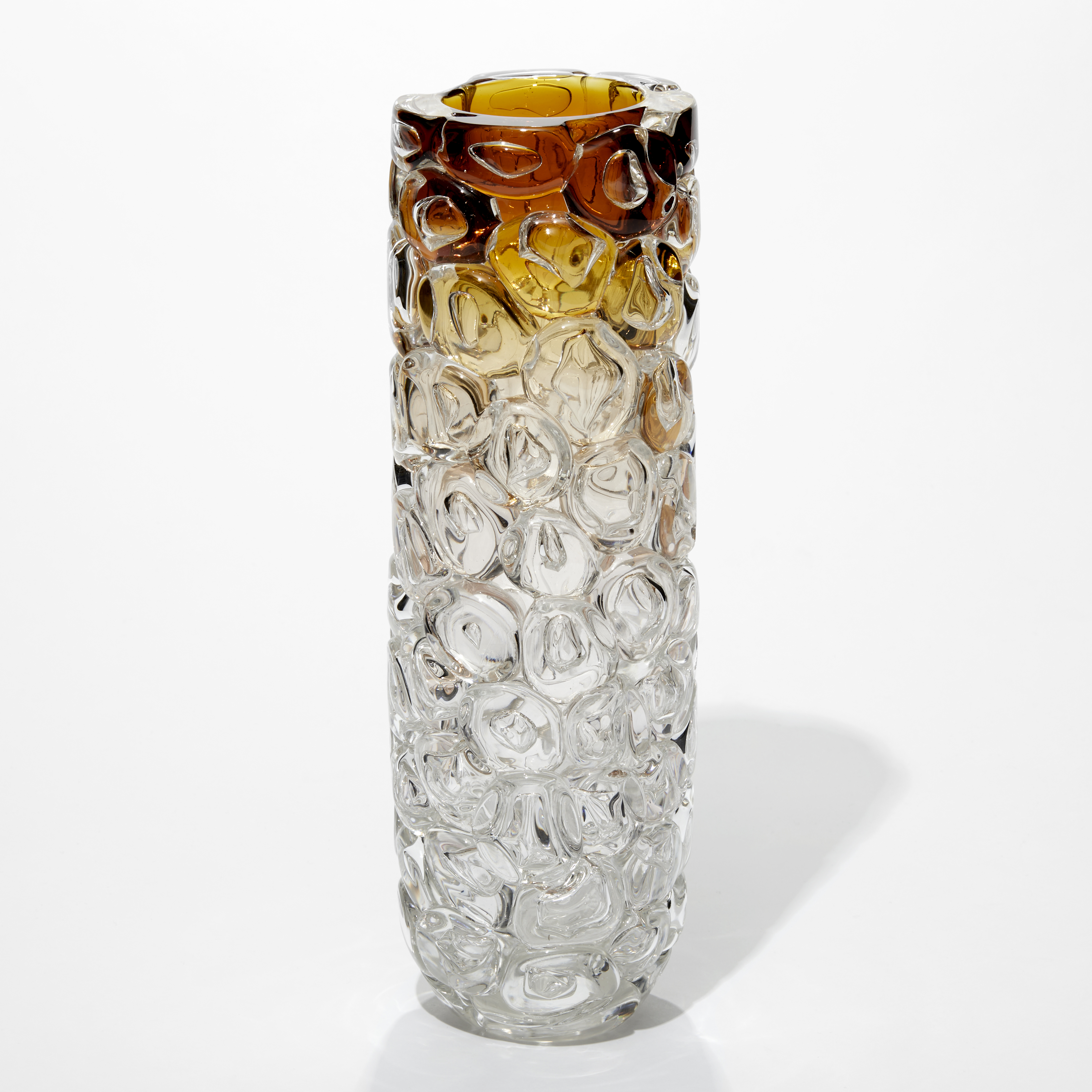 tall cylindrical transparent vase with an amber top fading to clear at the base with the surface covered is large oversized bubbles hand blown from glass