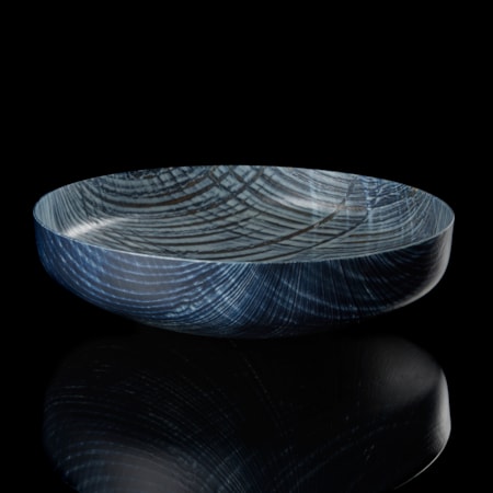 round centrepiece with curved base in soft dove grey and indigo blue with lined curved organic patterns over the surface hand made from glass