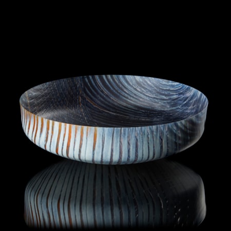 round opaque bowl in dark blue light grey and rust with organic curved lined patterns on the inside and outside hand made from fused glass