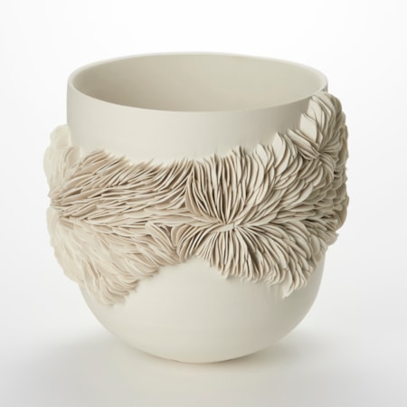 alabaster off white cream high sided bowl with a rounded base and an organic undulating band of small shards embedded and sticking out from the surface with the appearance of irregular rock strata hand made from porcelain
