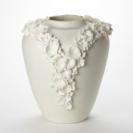 off white cream tall rounded vase with tapering base and narrowing top opening with a band of gold adorned with two lines of three dimensional flowers creating a v formation on the front like the plunging neck line of a ladies dress hand made from porcelain