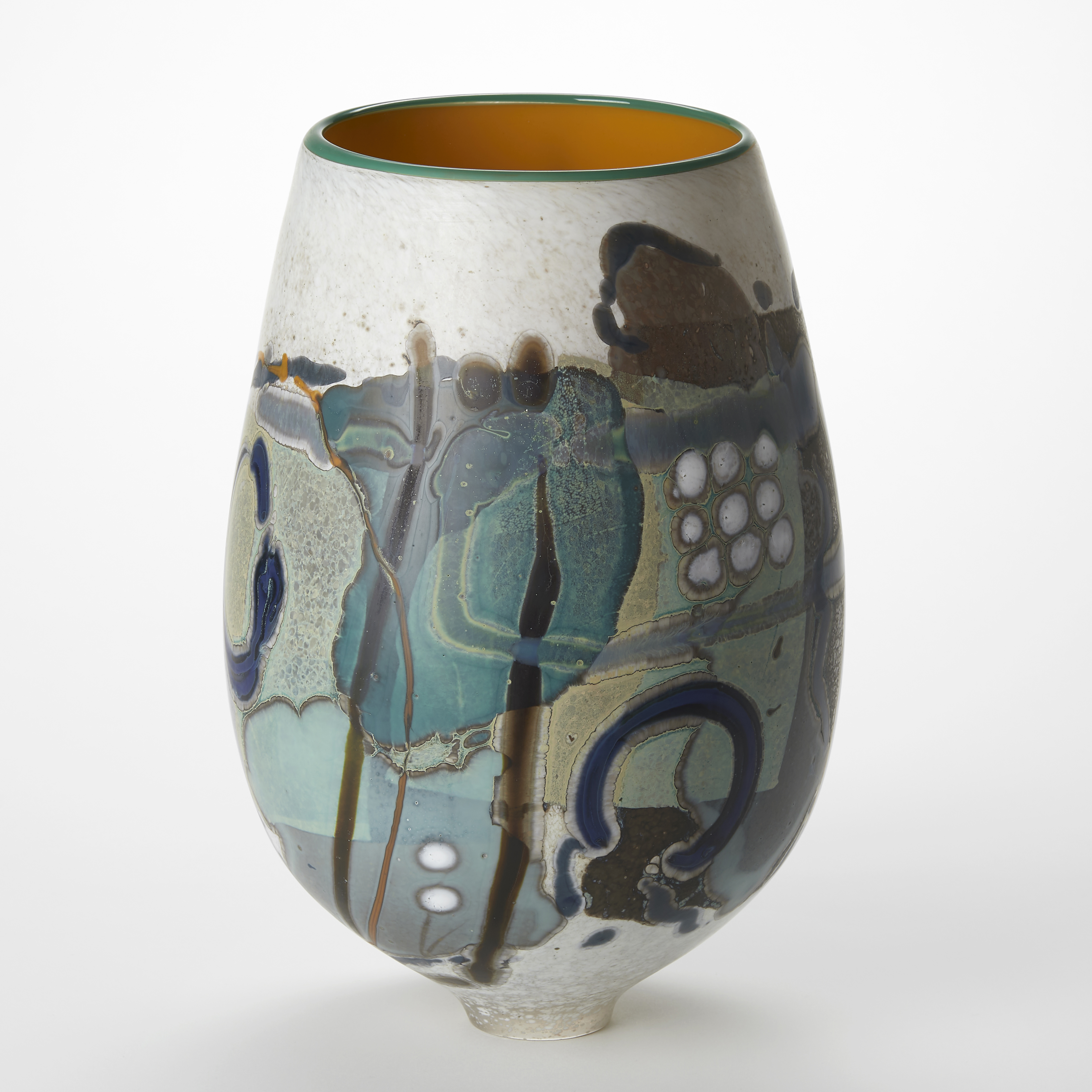 egg shaped vase with a matt exterior covered in abstract patterns in white teal black and sage green with a narrowing elegant foot and glossy interior in bright yellow with a green rim hand made from glass