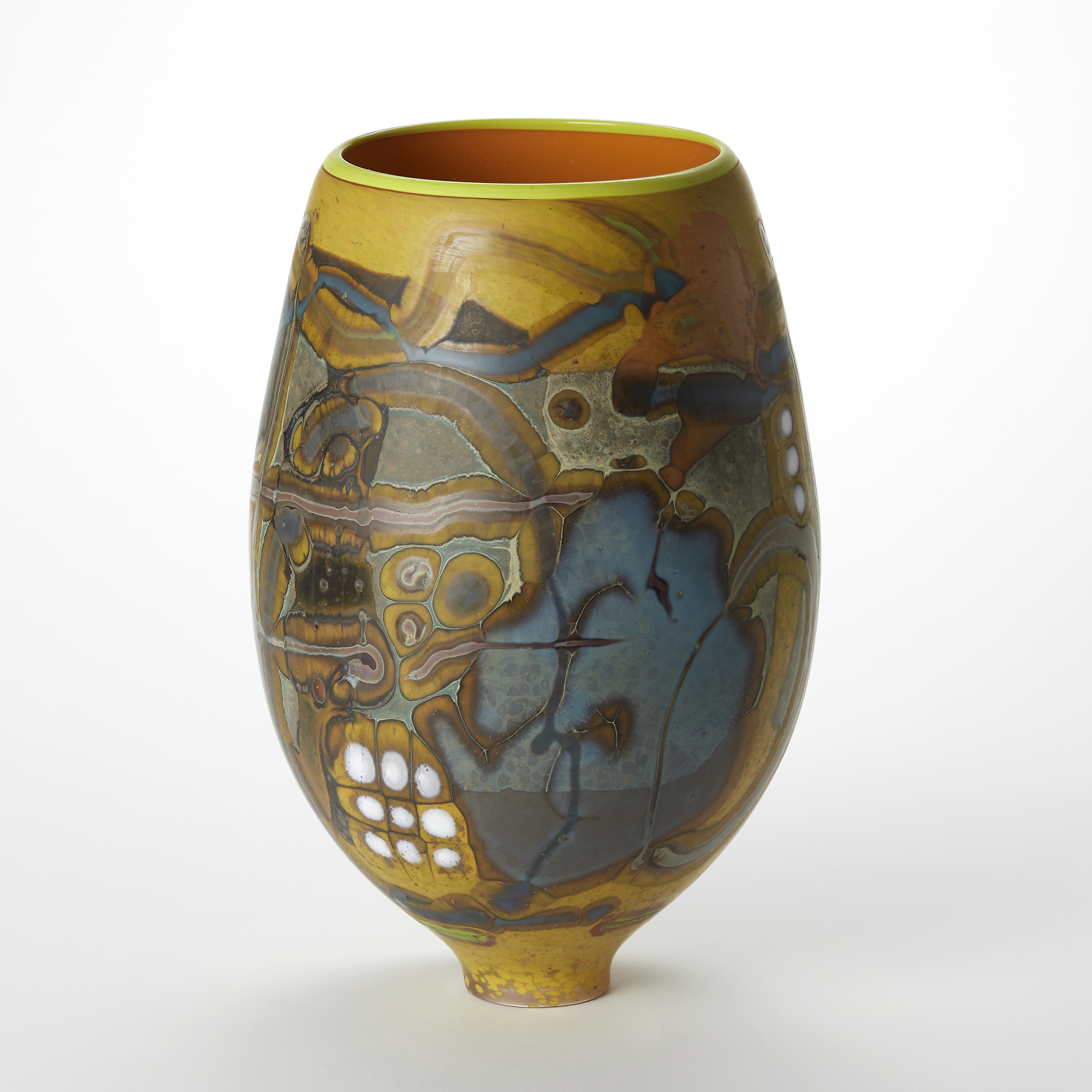 egg shaped vase with small narrow elegant foot and a wide top opening with the outside covered in matt abstract patterns in yellow lilac white blue and brown and the interior in glossy orange with a yellow rim hand made from glass