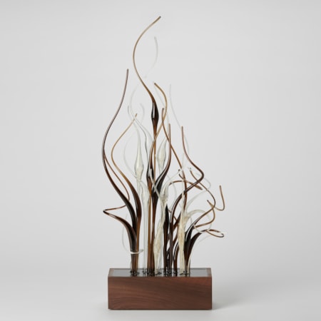 prone rectangular base with a bunch of curling canes set within it thrusting and curling upwards in brown clear and gold hand made from glass