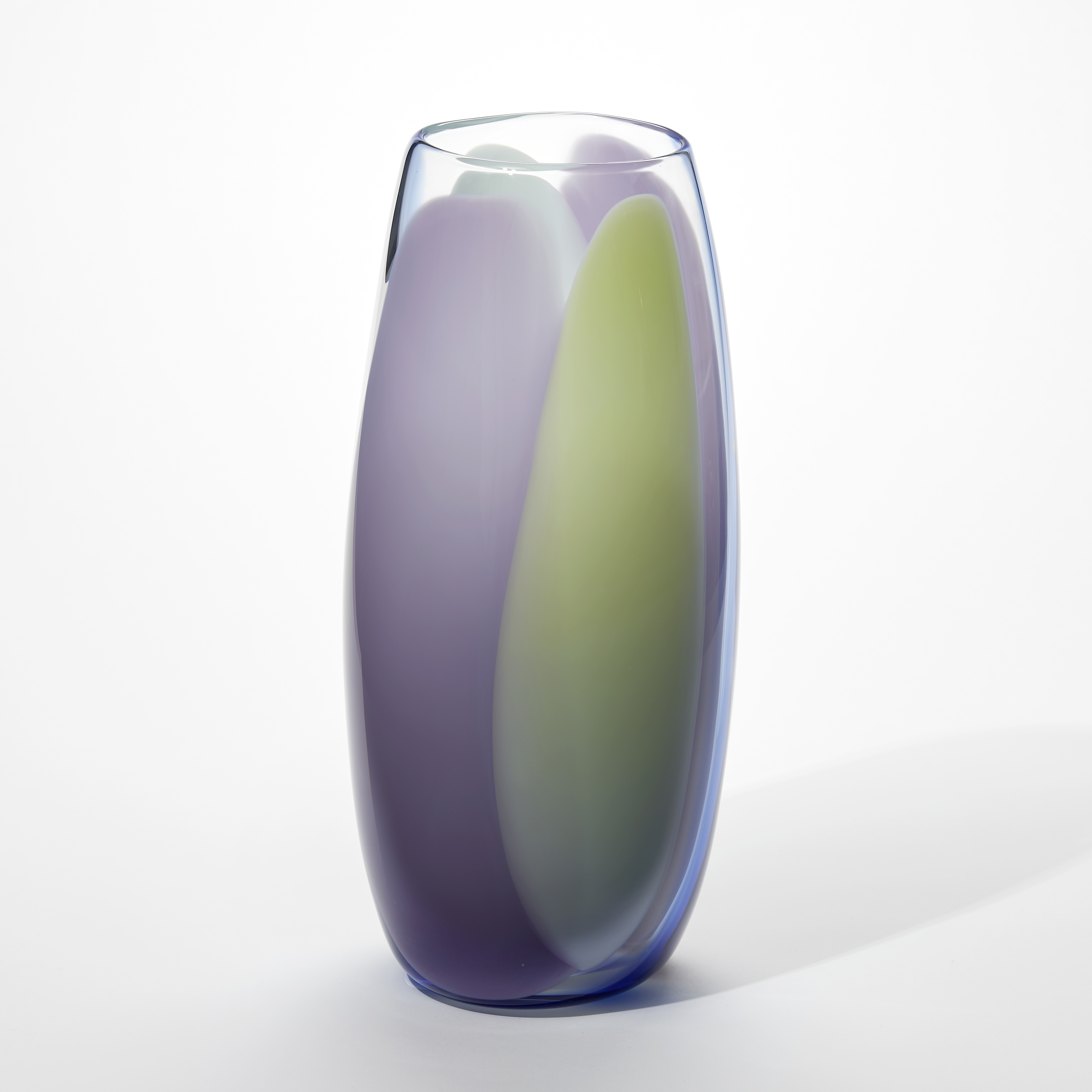 tall transparent soft cylinder vase with slightly bulging sides with vertical singular thick bands of opaque colour in purple turquoise and soft green hand blown from glass