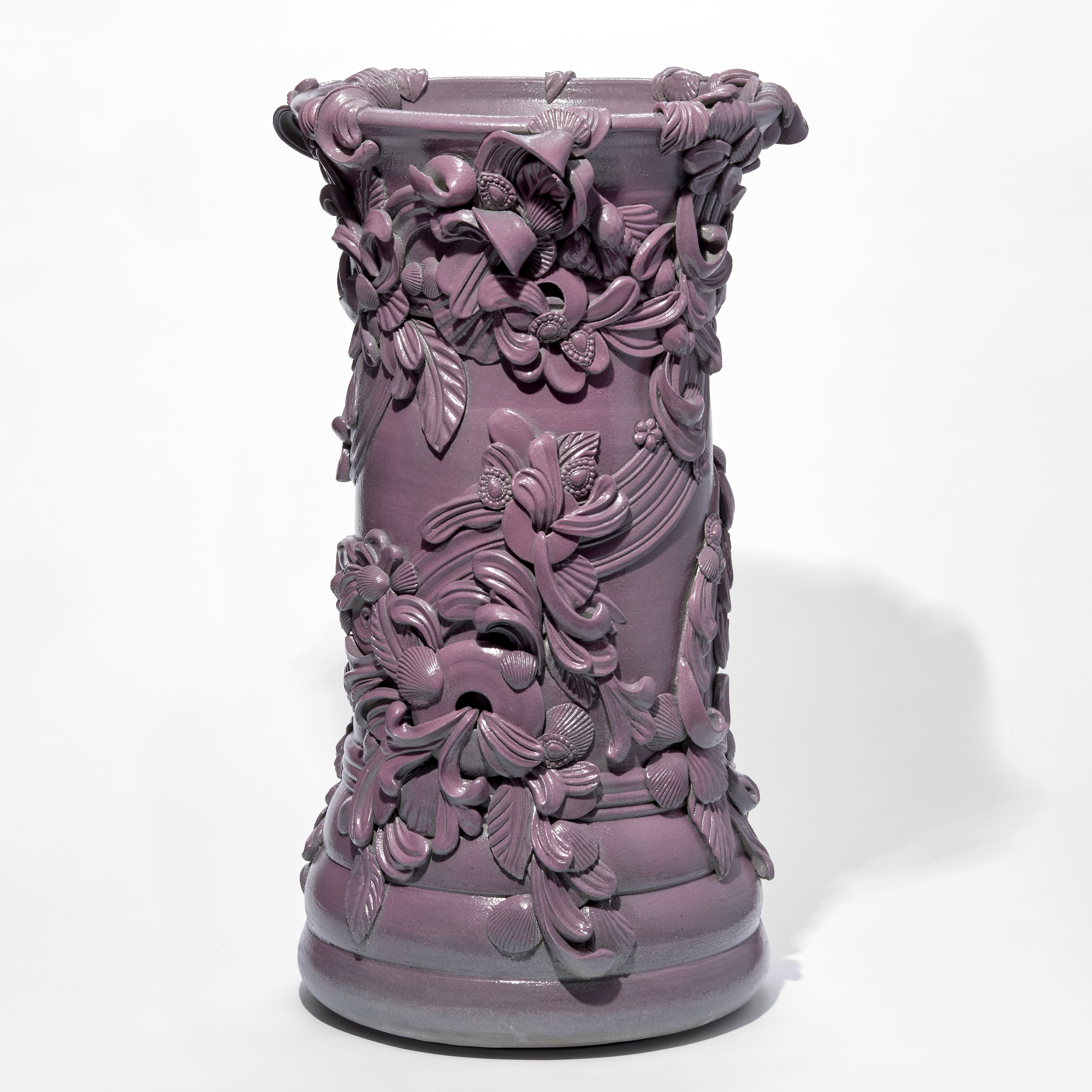 tall architectural column shaped vase with swirls and flourishes attached and encircling the exterior hand thrown from white saint thomas clay with a soft satin sheen rich dark pink glaze
