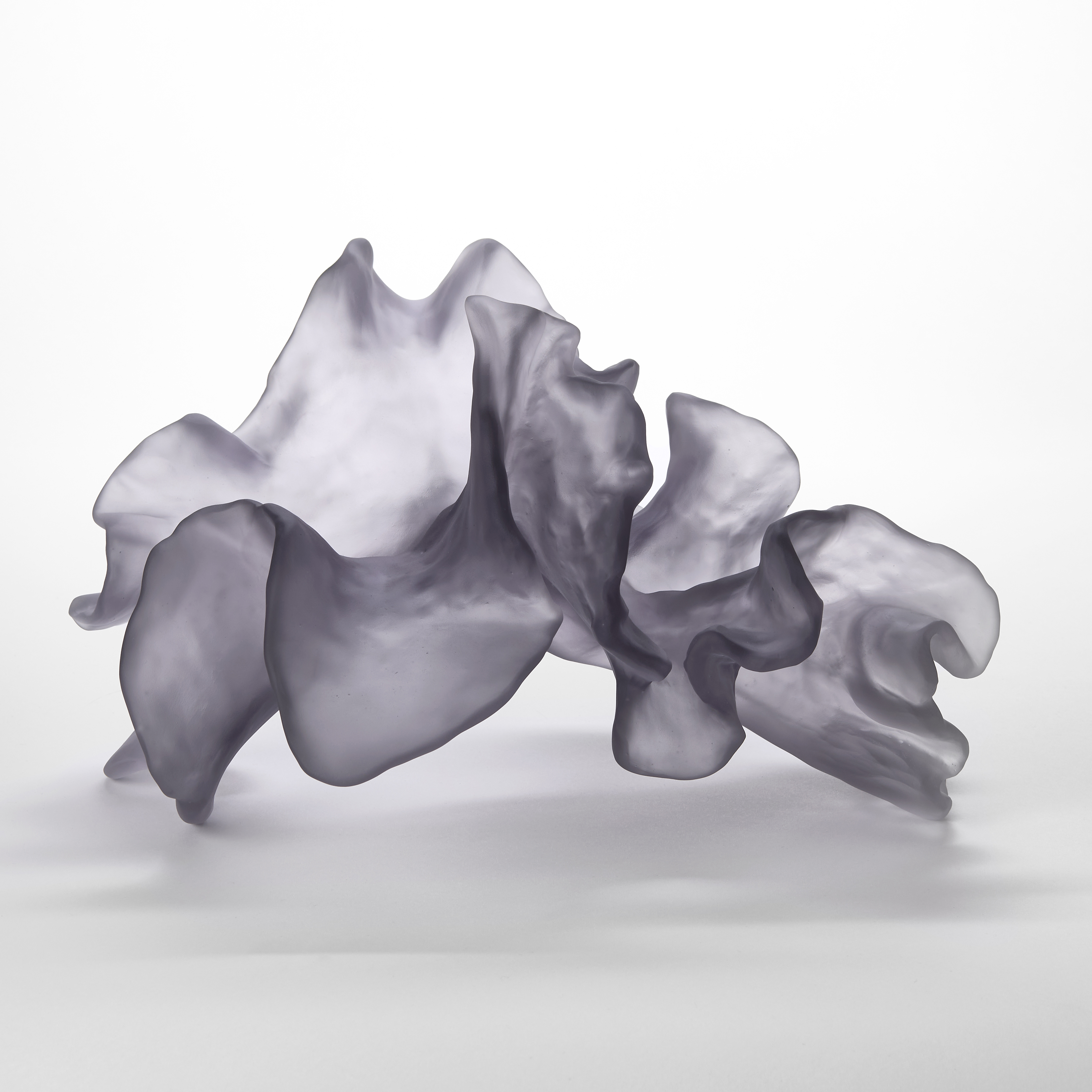 soft semi transparent purple lilac grey rippling organic sculpture with the appearance of coral hand made from glass