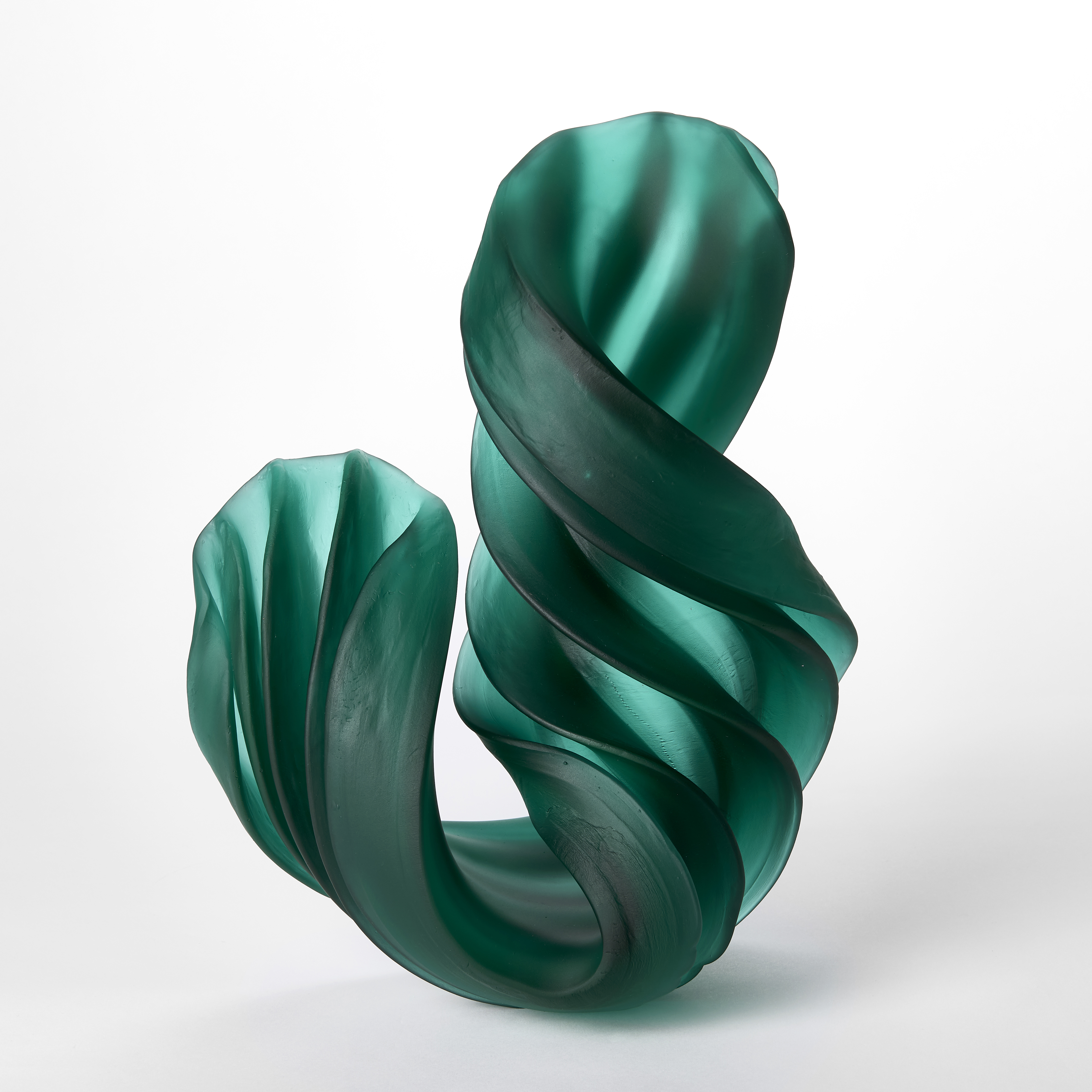 standing curling twisting thick ridged sculpture in semi transparent jade hand made from glass