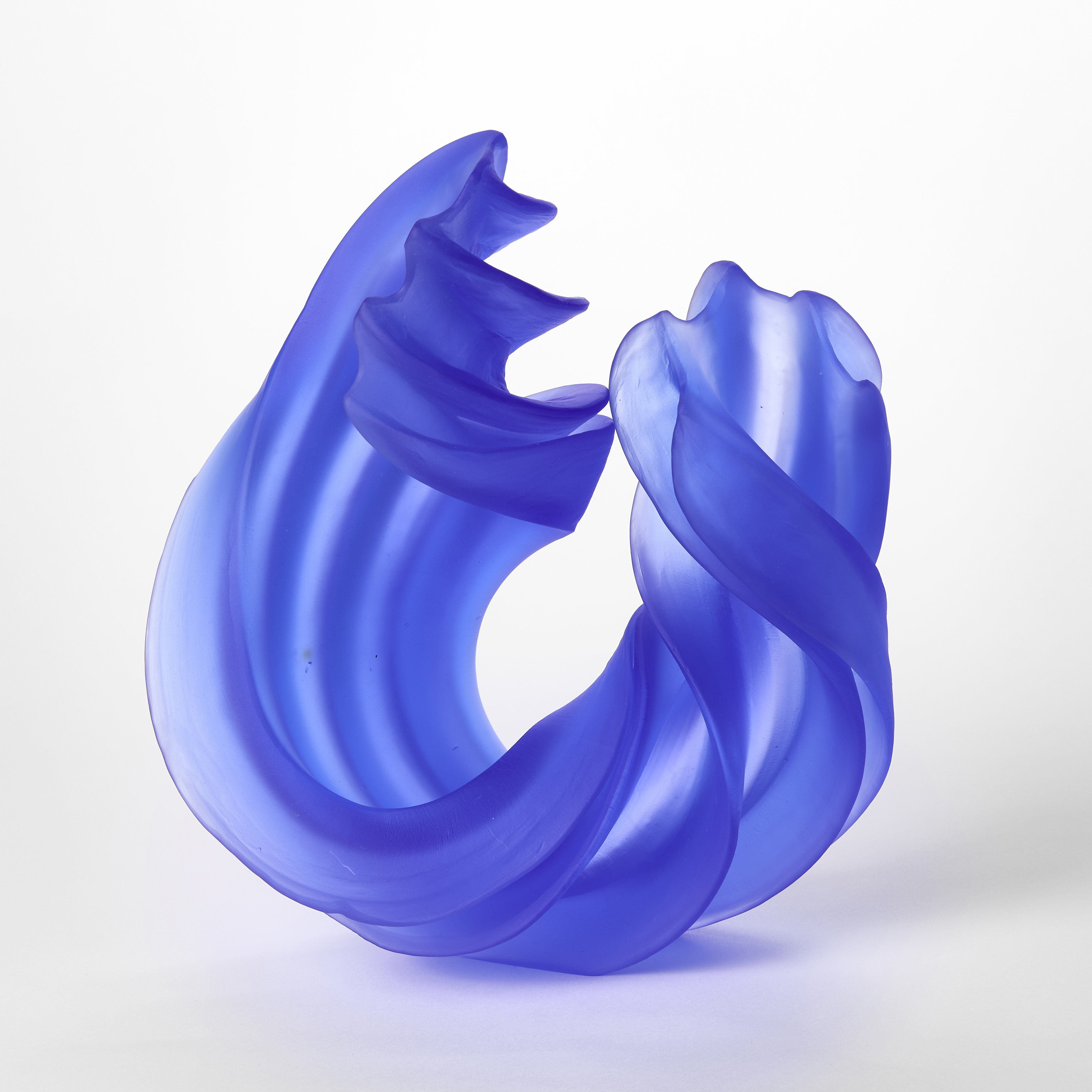 thick standing curling semi transparent blue sculpture with with ridges following the form hand made from glass