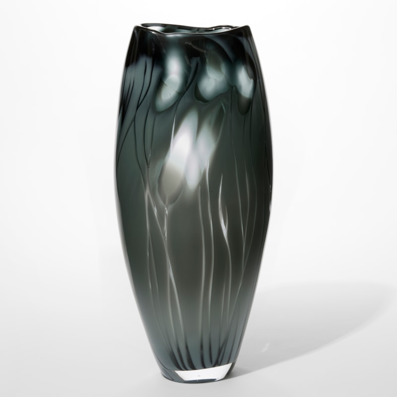 tall glossy opaque warm dark rich grey elegant glass vase with widening waist and irregular organic meandering soft top edge with ethereal abstract clear floral motifs and patterns hand blown from glass