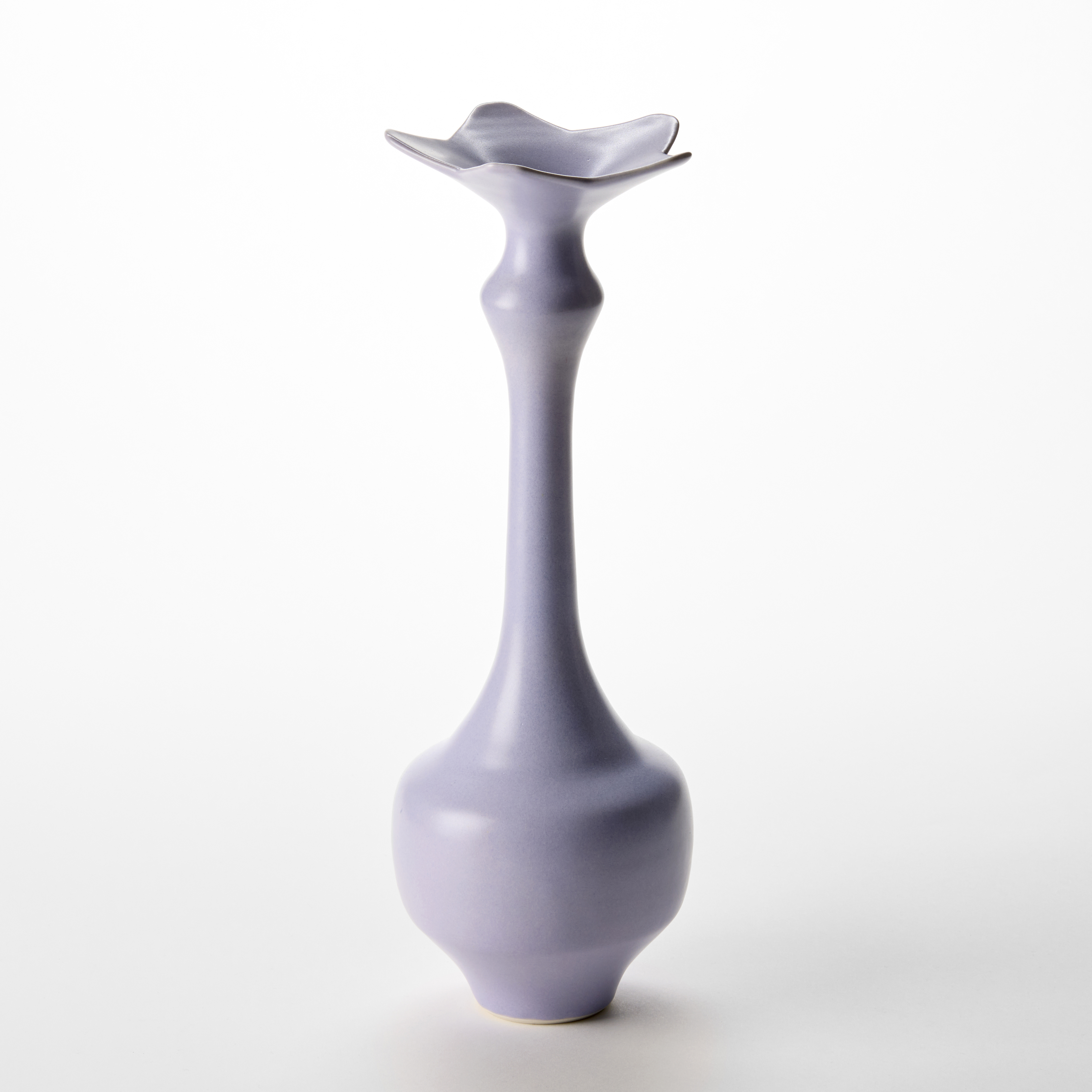 tall soft purple mauve vase with wide base narrowing to a long elegant neck with a top rim in the shape of a five pointed star hand thrown from porcelain