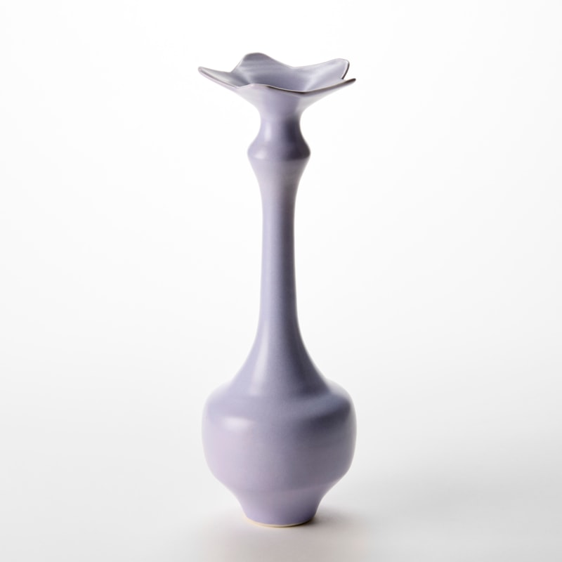 tall soft purple mauve vase with wide base narrowing to a long elegant neck with a top rim in the shape of a five pointed star hand thrown from porcelain