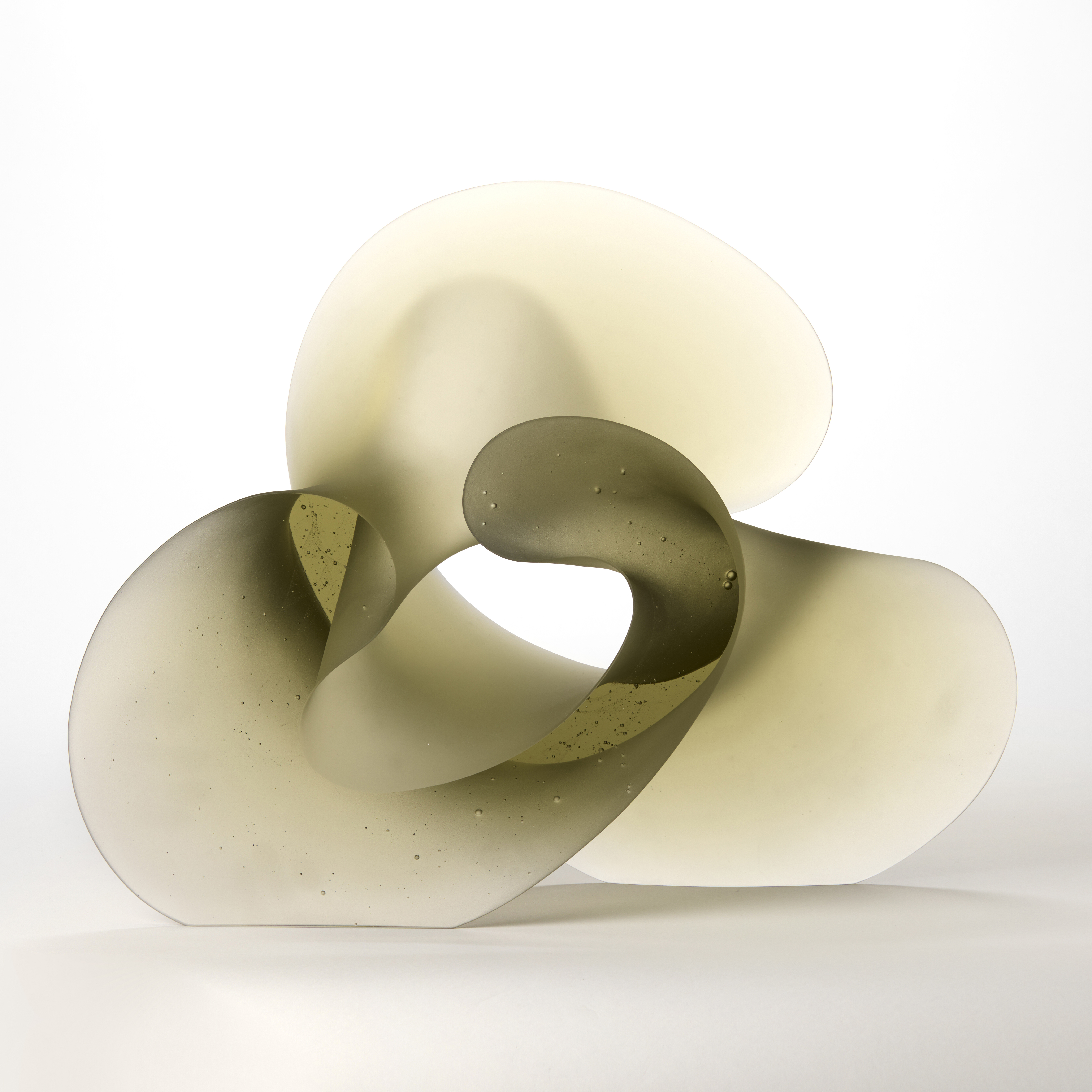 large semi transparent soft bronze curling abstract sculpture with the appearance of a calligraphy flourish with a shiny front and ack and frosted edge hand made from cast glass