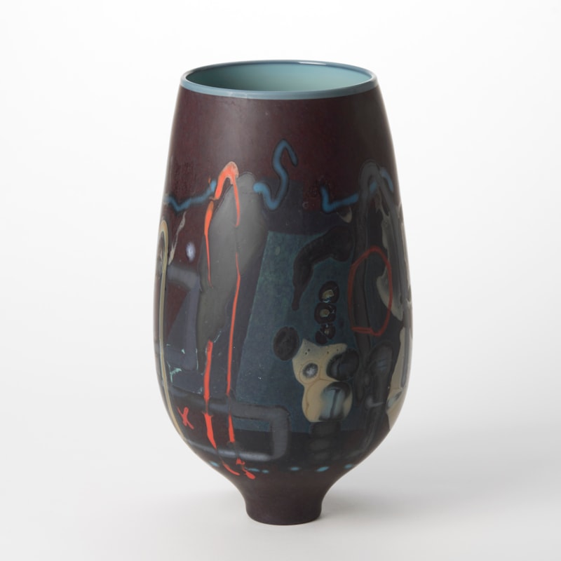 tall opaque dark purple aubergine vase with a glossy teal blue interior and exterior covered in abstract lines and patterns in red midnight blue grey and ochre hand blown from glass