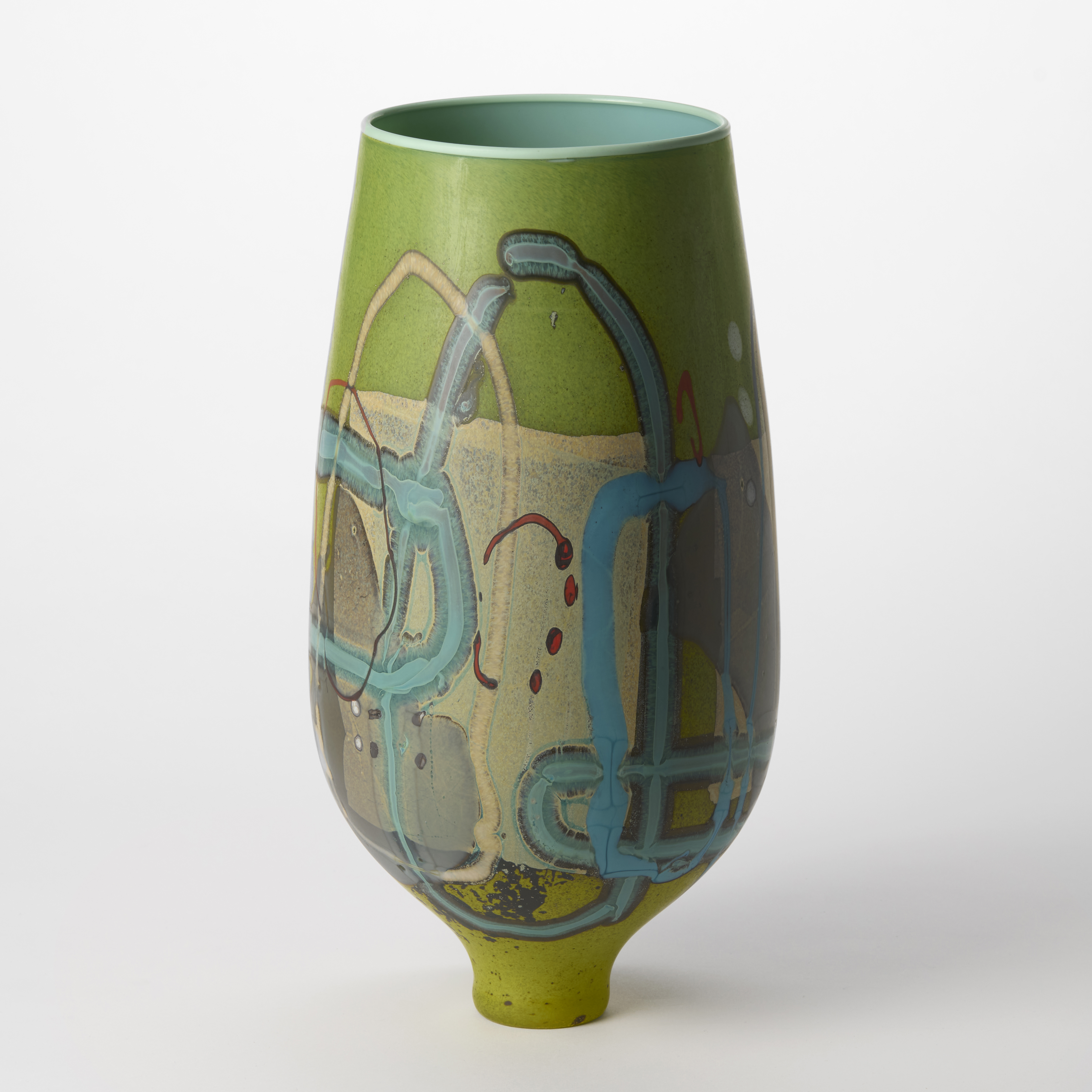 opaque rich apple green tapered tall rounded vase perched on a narrow elegant foot and abstract surface decoration in aqua teal ochre grey and red with a glossy turquoise interior hand blown from glass 