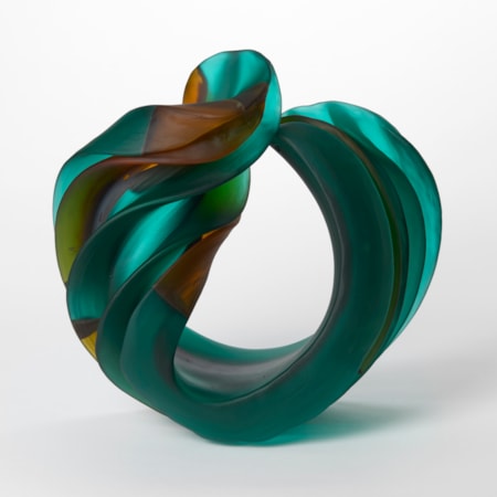 curled semi transparent jade green ridged heavy rounded form with sparse sections in orange and amber hand made from glass