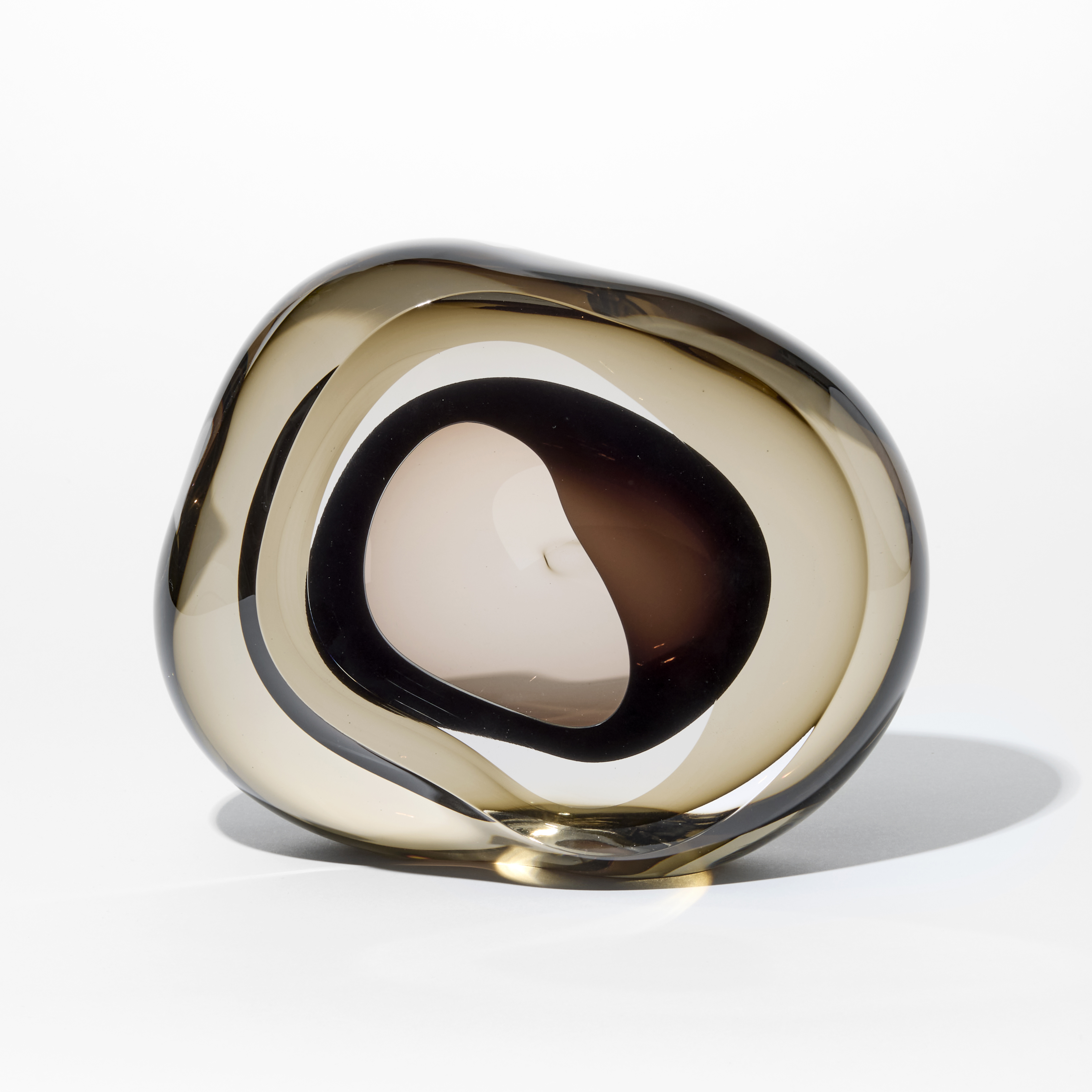 soft low rounded transparent bronze coloured pebble with front organic opening lined with transparent rich brown hand made from glass