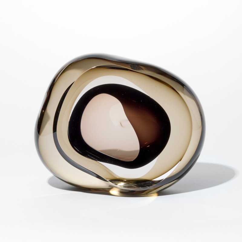 soft low rounded transparent bronze coloured pebble with front organic opening lined with transparent rich brown hand made from glass
