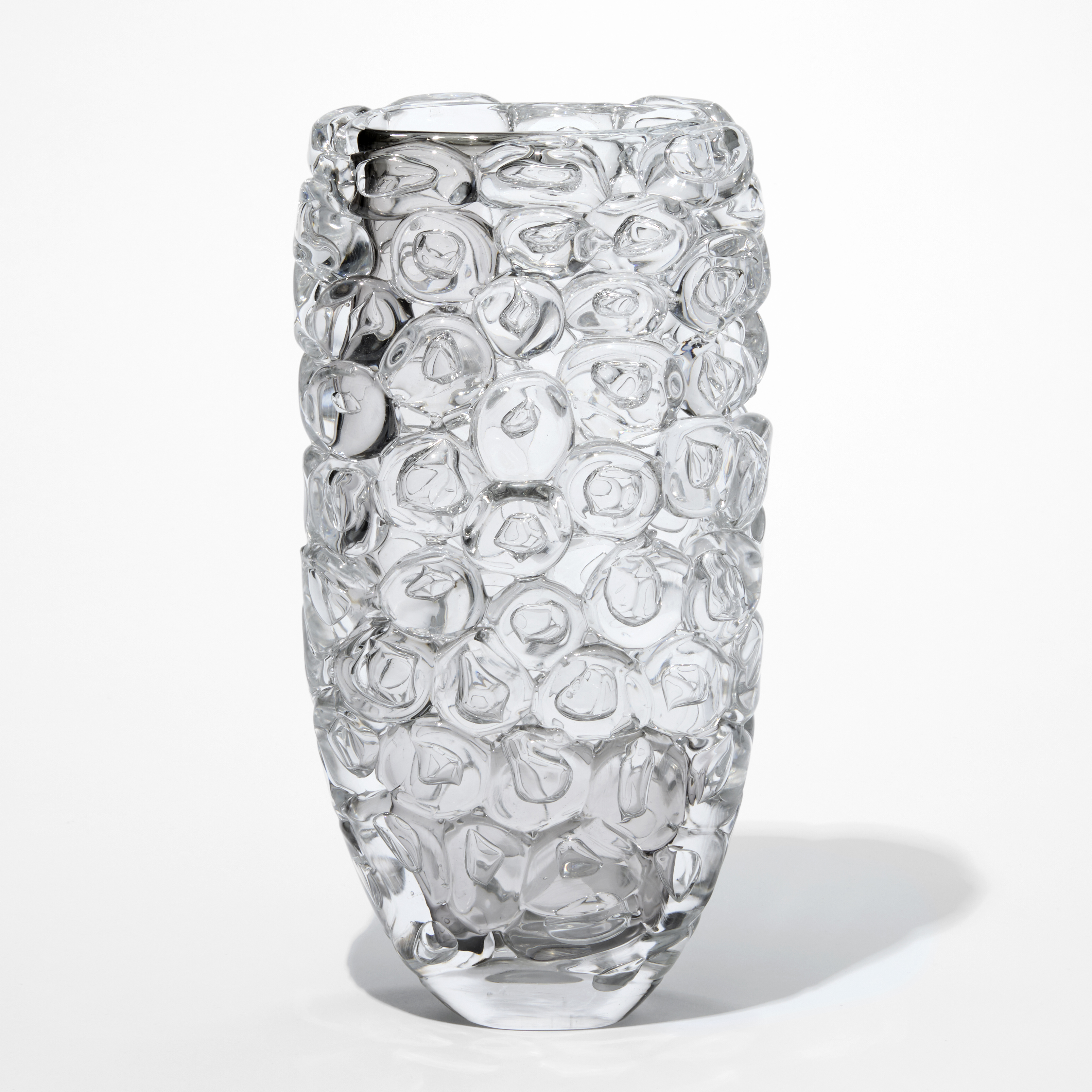 tall transparent clear and grey vase with a slightly flaring shape and outer covered in stocked oversized squashed bubbles hand made from glass