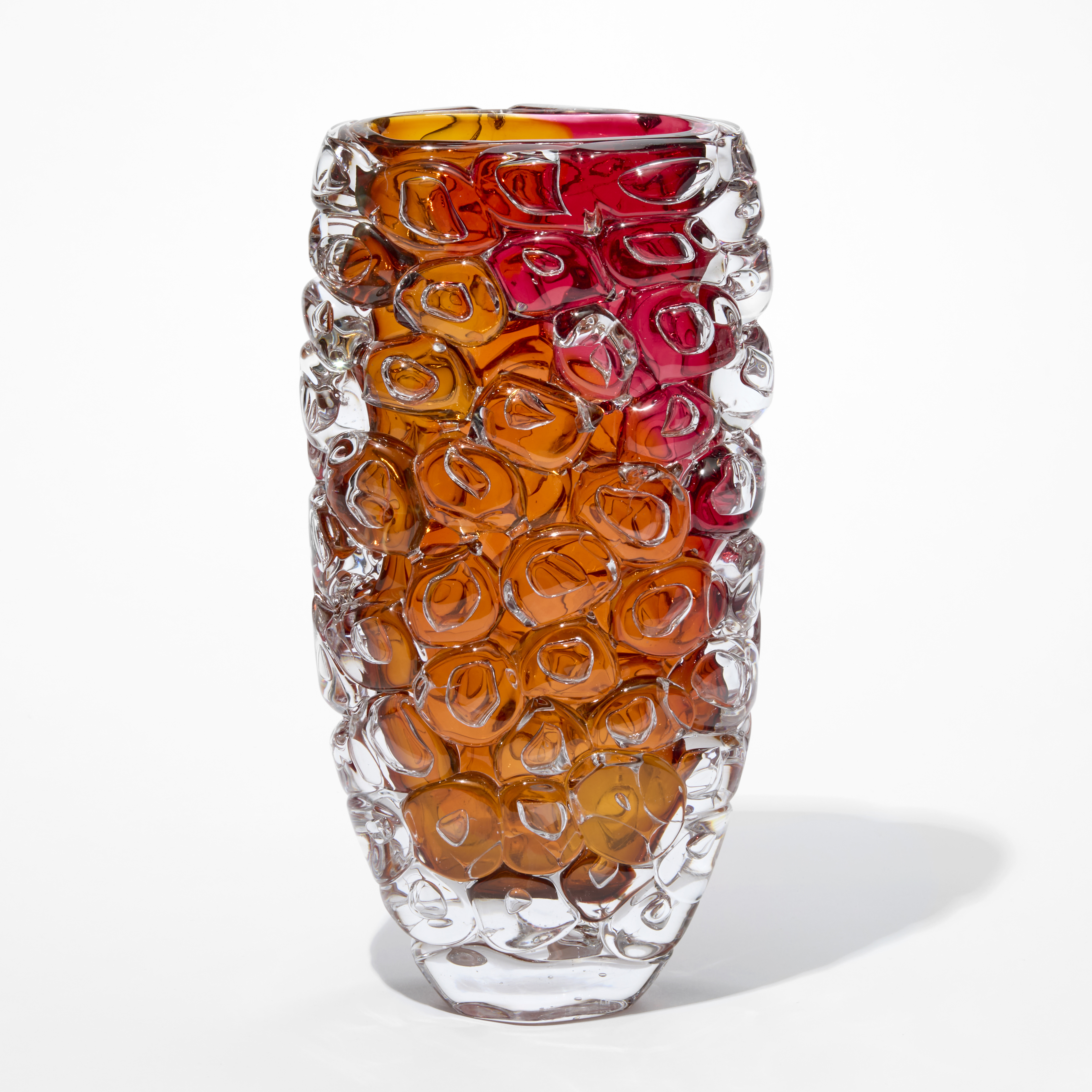 tall slightly flaring transparent vase with rich burnt orange and magenta core covered in large over sized squashed bubbles like it has been wrapped in bubble wrap hand blown from glass