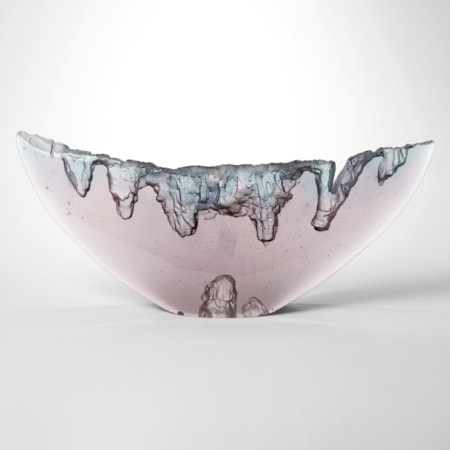 transparent watery soft aubergine and steel blue abstract sculpture shaped like a whales tail with a glossy exterior and curved top edge with internal rock like craggy textures hand made from cast glass